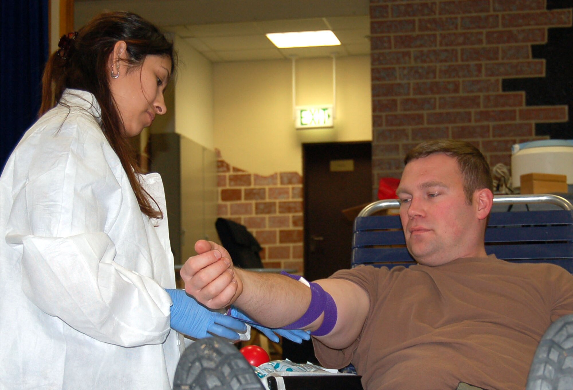 SPANGDAHLEM AIR BASE, Germany – Jeanette Salabarria, Landstuhl Regional Medical Center Armed Services Blood Bank Center – Europe, wraps the arm of Tech. Sgt. Timothy Albert, 52nd Civil Engineer Squadron, after he donated blood at the base blood drive, Feb. 6, 2008. (U.S. Air Force photo/Staff Sgt. Tammie Moore)