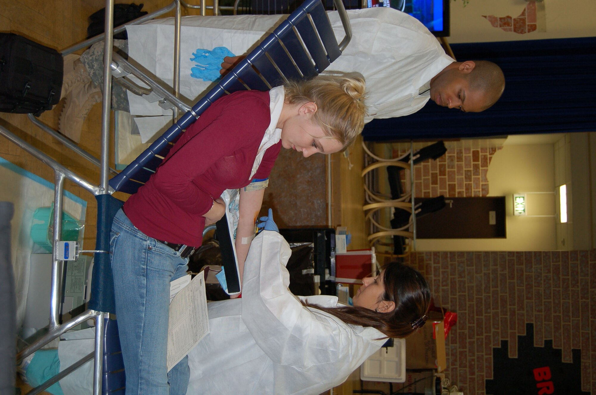 SPANGDAHLEM AIR BASE, Germany – Army Sgt. Fred Campbell looks on as Jeanette Salabarria, both from Landstuhl Regional Medical Center Armed Services Blood Bank Center – Europe, prepares to draw blood from Elisha Peters during a base blood drive Feb. 6, 2008. Mrs. Peters is the spouse of Airman 1st Class Glenn Peters, 52nd Equipment Maintenance Squadron. (U.S. Air Force photo/Staff Sgt. Tammie Moore)