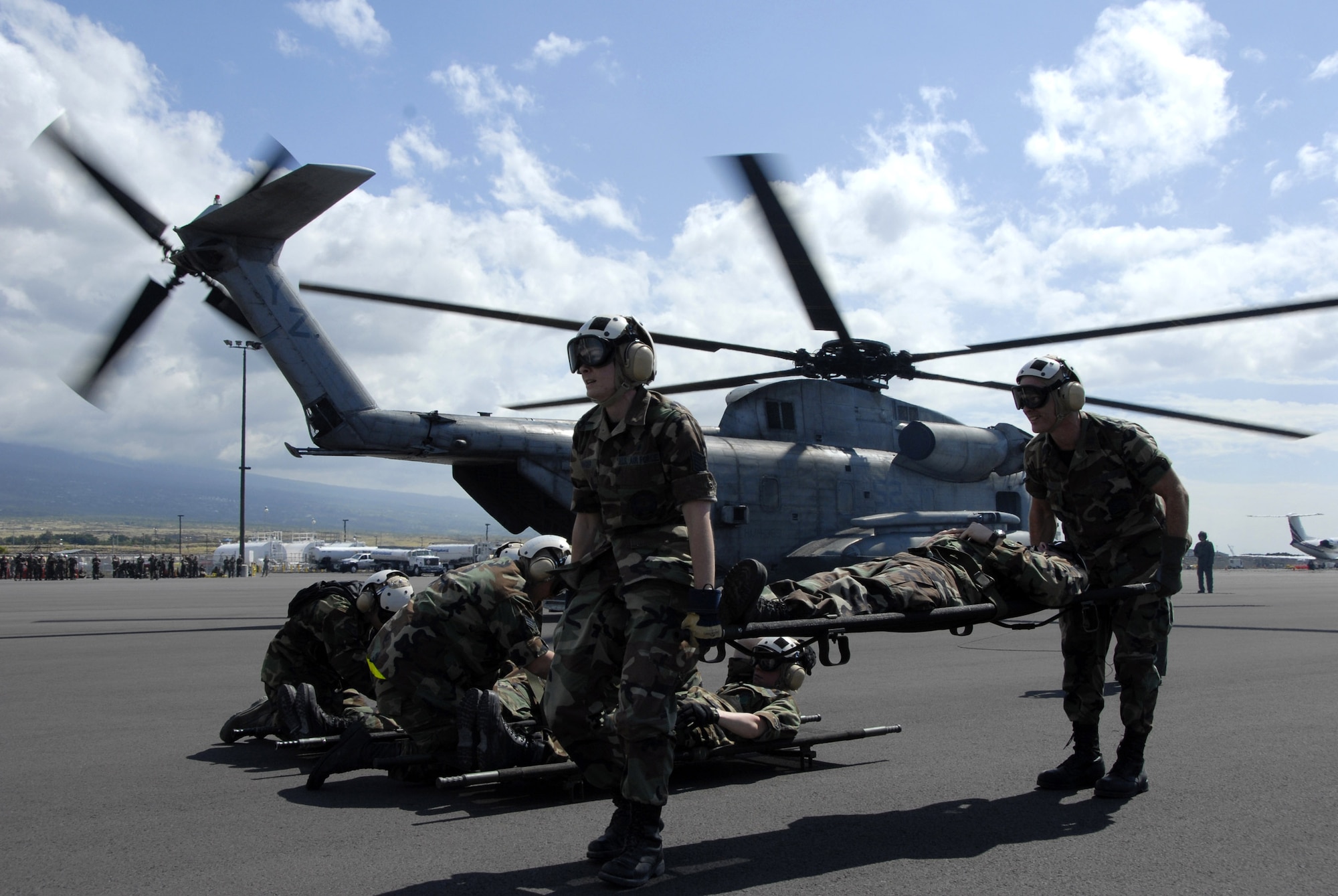 Personnel from the expedtionary medical members at exercise Pacific Lifeline lift and prepare to transport a paitent on to a CH-53D Sea Stallion helicopter. The EMEDS were going thtough refresher training courses taught by cadre from a 14-person Expeditionary Medical Support Training Team currently deployed to Kona, Hawaii, from Brooks City-Base, Texas, to train, evaluate and add realism to exercise scenarios.Pacific Lifeline is a  Pacific Air Forces total force humanitarian assistance and disaster relief exercise being held at the Kona International Airport, Hawaii, now through Feb. 9. (U.S. Air Force photo/Tech. Sgt. Tom Czerwinski) 