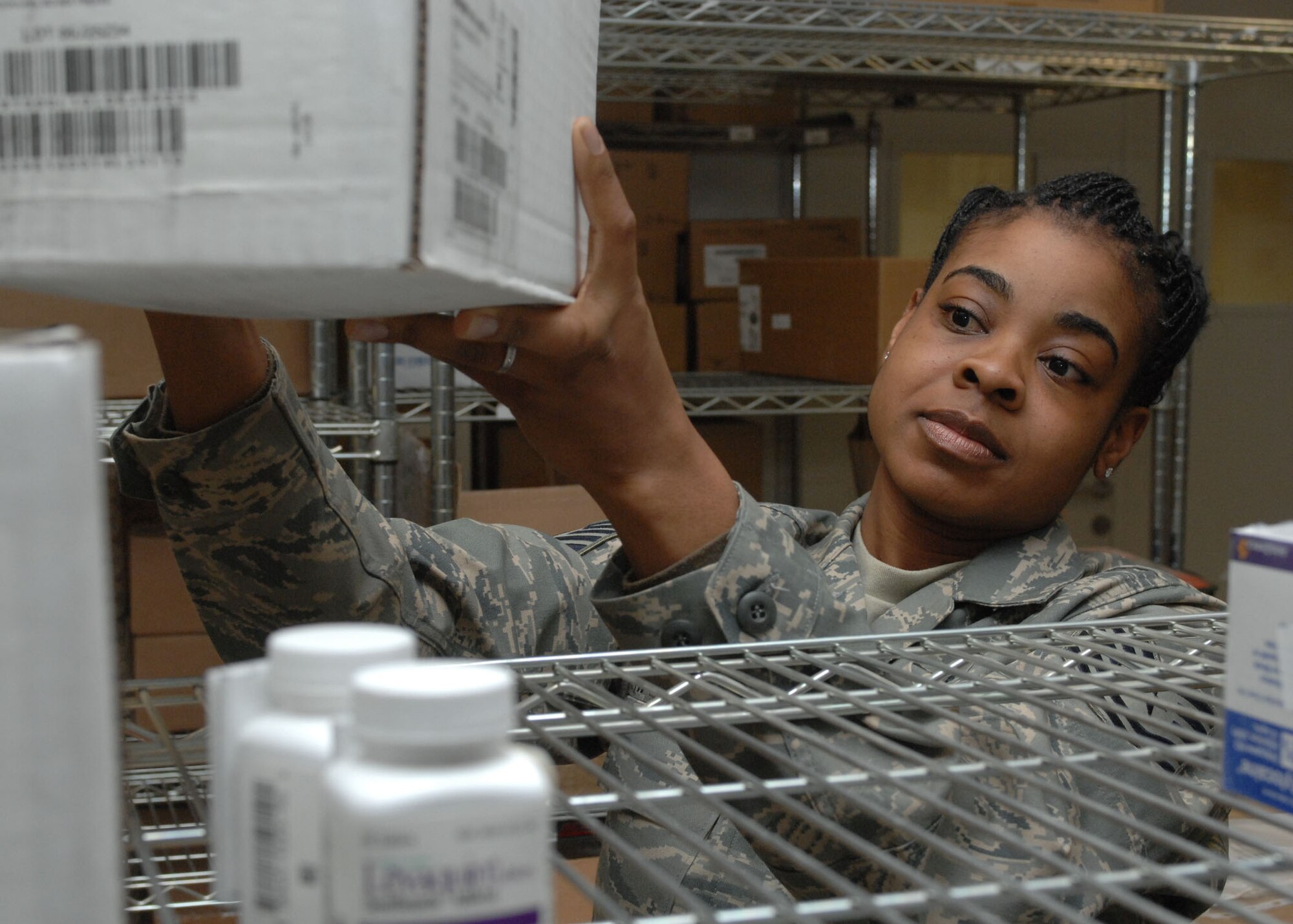 BAGRAM AIR BASE, Afghanistan – Tech. Sgt. Marygail Harmon, noncommissioned officer in charge of medical material at the Craig Joint Theater Hospital here, stocks supplies in the logistics store room Feb. 5. Harmon's home unit is the 96th Medical Support Squadron at Eglin Air Force Base, Fla., where she is a medical supply technician. (U.S. Air Force photo by Master Sgt. Demetrius Lester)


