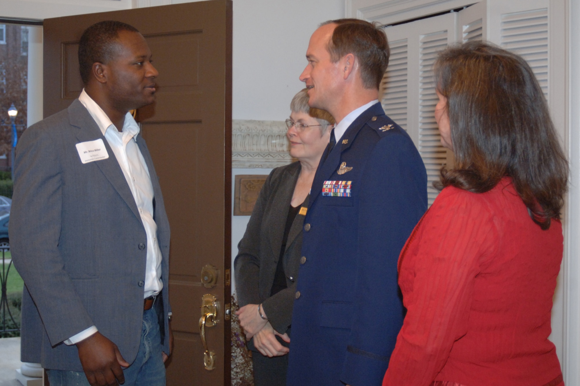 Jazz musician and Honorary Commander for the 14th Force Support Squadron, provisional, Brice Miller is greeted by MUW President and host, Dr Claudia Limbert; 14th Flying Training Wing commander Colonel David Gerber and his wife Louisa at the Honorary Commander reception held at Dr Limberts home. (U.S. Air Force photo by Airman 1st Class Danielle Hill)