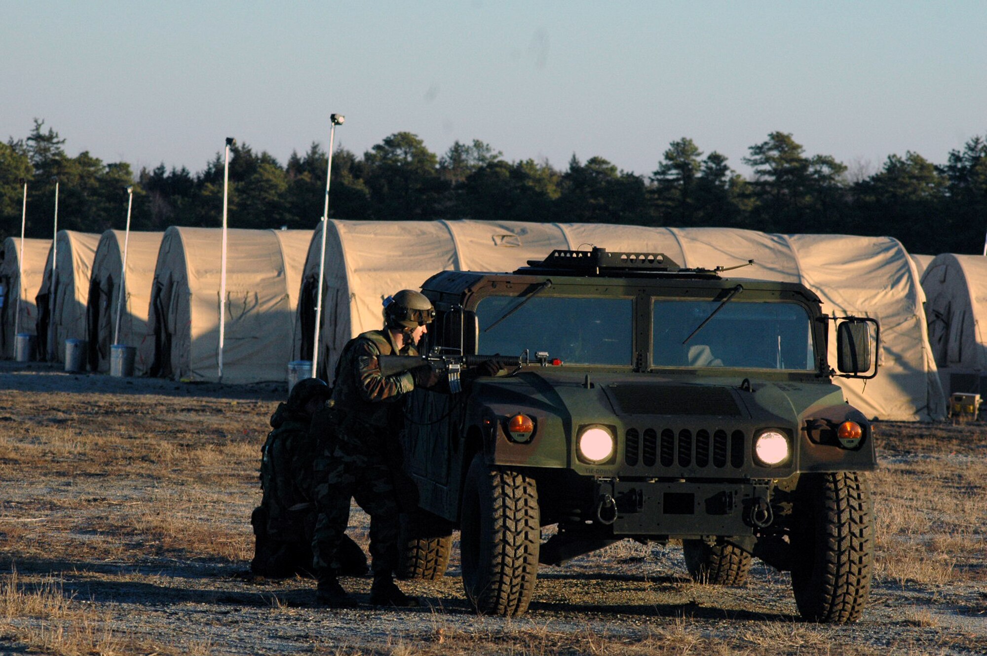 Airmen deployed to Air Force Exercise Eagle Flag 08-2 respond to an opposing forces attack on their camp during a scenario for the exercise Jan. 23, 2008, at Naval Air Engineering Station Lakehurst, N.J.  The exercise is operated by the U.S. Air Force Expeditionary Center's Expeditionary Operations School and the 421st Combat Training Squadron from Fort Dix, N.J.  (U.S. Air Force Photo/Tech. Sgt. Scott T. Sturkol)