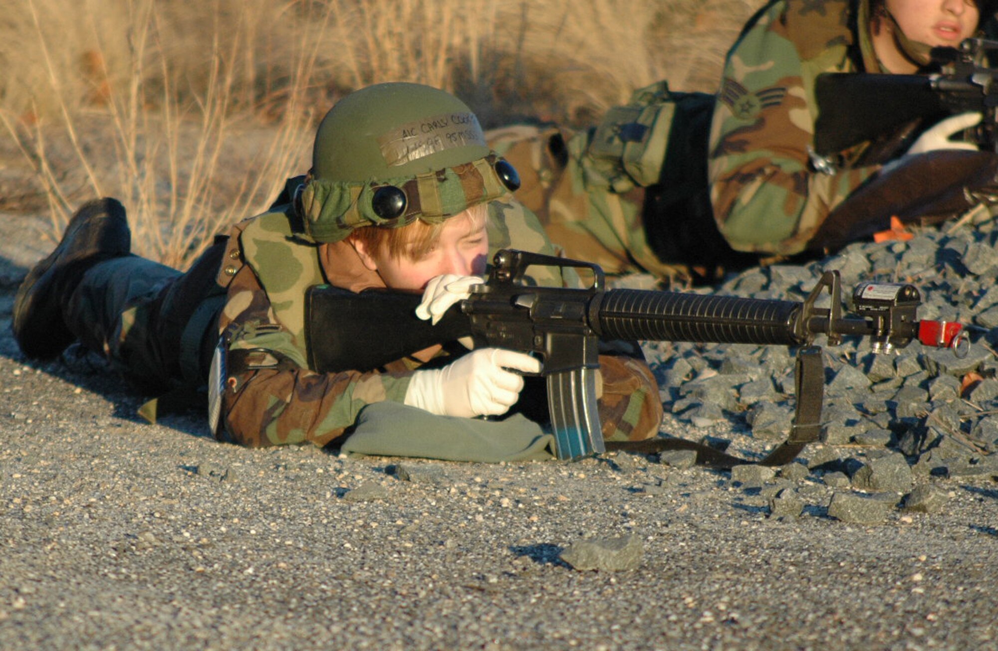 Airman 1st Class Carly Cooper, 95th Mission Support Squadron, Edwards Air Force Base, Calif., reacts to "opposing forces" fire during an event for Air Force Exercise Eagle Flag 08-2 Jan. 23, 2008, at Naval Air Engineering Station Lakehurst, N.J.  The exercise is operated by the U.S. Air Force Expeditionary Center's Expeditionary Operations School and 421st Combat Training Squadron from Fort Dix, N.J.  (U.S. Air Force Photo/Tech. Sgt. Scott T. Sturkol)