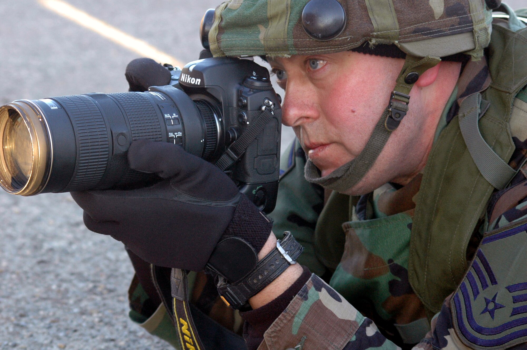 Master Sgt. Kevin Gruenwald, photographer from the 99th Air Base Wing public affairs office, Nellis Air Force Base, Nev., takes photos during an event for Air Force Exercise Eagle Flag 08-2 at Naval Air Engineering Station Lakehurst, N.J., Jan. 23, 2008.  Sergeant Gruenweld was one of five members of a PA team who deployed to the exercise. The exercise is operated by the U.S. Air Force Expeditionary Center's Expeditionary Operations School and 421st Combat Training Squadron at Fort Dix, N.J.  (U.S. Air Force Photo/Tech. Sgt. Scott T. Sturkol)