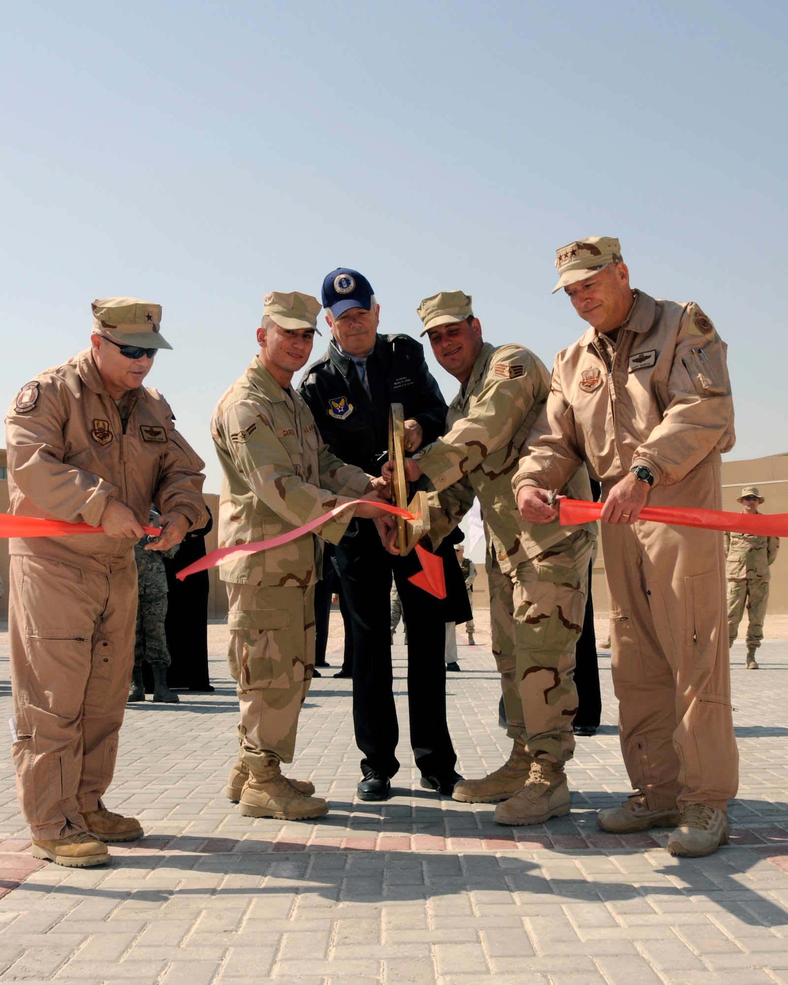 The grand opening ceremonies of the Blatchford-Preston Complex included a ribbon cutting ceremony at the Community Mall, fitness center, dining facility and one of the dormitories. (From left) Brig. Gen. Charlie Lyon, Airman 1st Class Jose Cardoza, Secretary of the Air Force Michael W. Wynne, Staff Sgt. Aaron Johnson and Lt. Gen. Gary North cut the ribbon, marking the official opening of the new dining facility. (U.S. Air Force photo/Senior Airman Domonique Simmons)