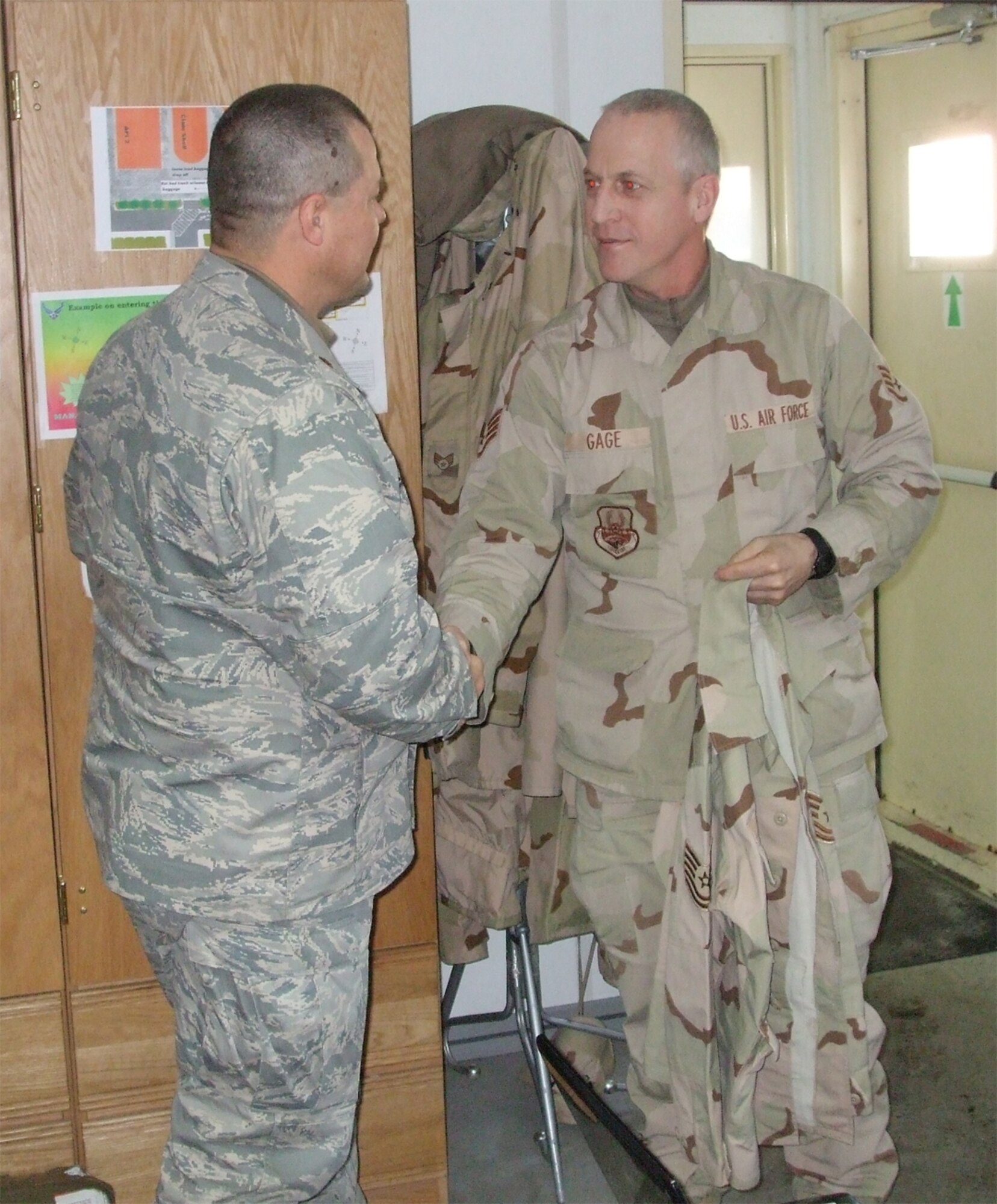 SEYMOUR JOHNSON AIR FORCE BASE, N.C.-- Newly promoted Tech. Sgt. Glenn Gage (right) receives his stripes while deployed to Manas Air Base, Kyrgyzstan in February. Sgt. Gage is a member of the 916th Logistics Readiness Squadron. Congratulating him to his  left is Maj. Michael McDonnald, deployed commander.