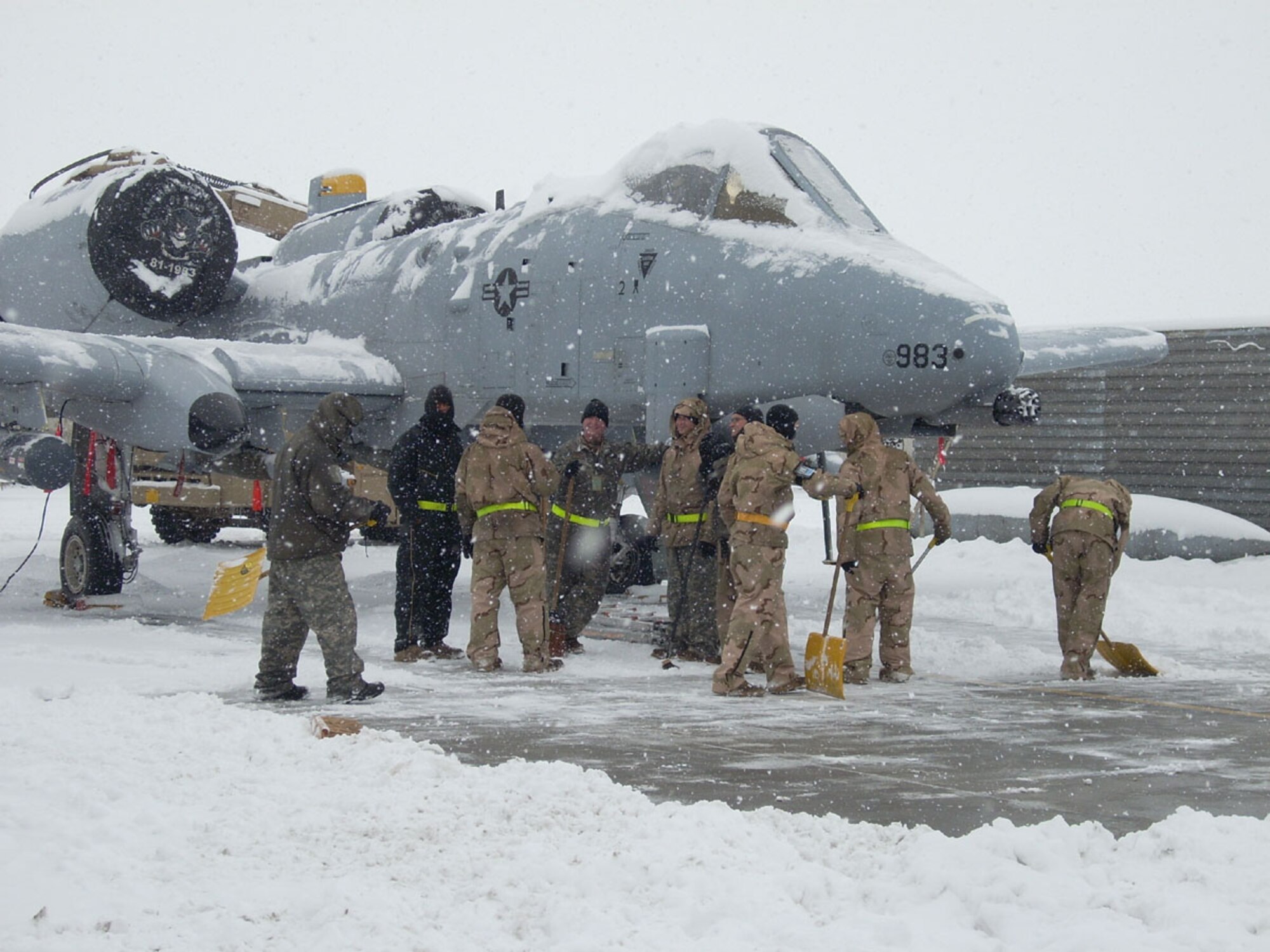 BAGRAM AIR BASE, Afghanistan -- Maintainers from the 81st Expeditionary Aircraft Maintenance Unit work in less than optimal weather conditions here. The maintainers are deployed from the 52nd Aircraft Maintenance Squadron, Spangdahlem AB, Germany. (Courtesy photo)