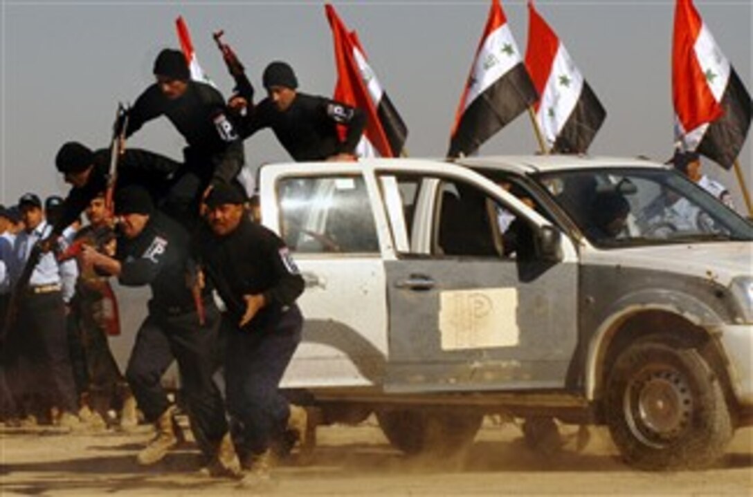 Iraqi police graduates dismount a patrol vehicle during a demonstration of what they learned during training at the Camp Fiji Iraqi Police Training Facility, Feb. 2, 2008.
