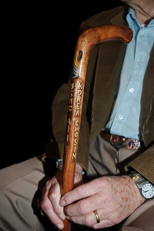 Former Staff Sgt. Richard Gilbert displays a cane he had made that identifies the unit he served with during the Chosin Reservoir campaign; Alpha Company, 1st Battalion, 1st Marines Regiment, 1st Marine Division.  Gilbert was interviewed by Capt. Iglesias for the documentary "Chosin."