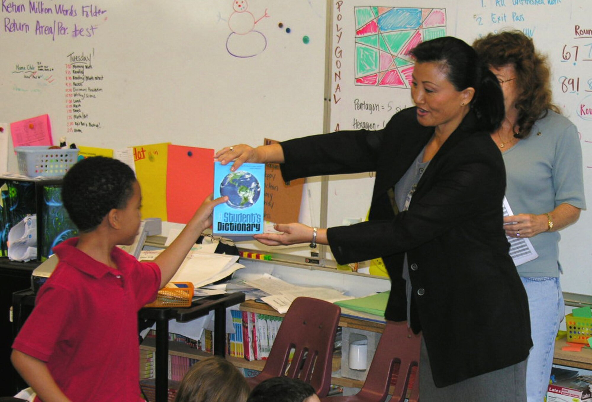 Pearl Harbor Rotarians distribute copies of "a student's dictionary" at Hickam Elementary Shcool.