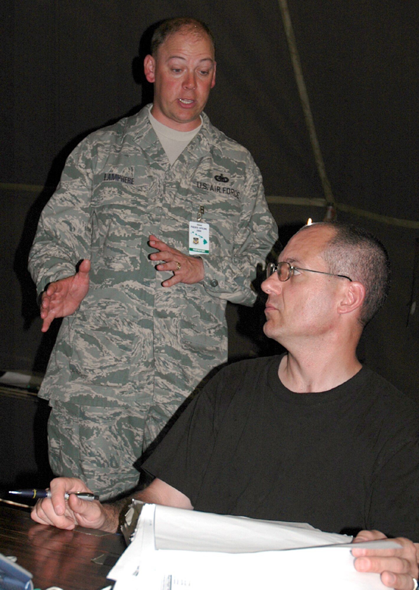 Master Sgt. Todd Lamphere, 446th Aerospace Medicine Squadron first sergeant from McChord Air Force Base, Wash., talks with Tech. Sgt. Mark Marinov, one of the PERSCO team members from the 446th Mission Support Squadron, during the Pacific Lifeline exercise.  Sergeant Lamphere is the first sergeant for everyone at Kauai during the exercise.  Pacific Lifeline is a humanitarian assistance disaster response exercise taking place on three Hawaiian Islands Jan. 26 to Feb. 9.  More than 900 Department of Defense personnel are participating, including 145 Reservists from the 446th Airlift Wing at McChord. (U.S. Air Force photo/Capt. Jennifer Gerhardt)