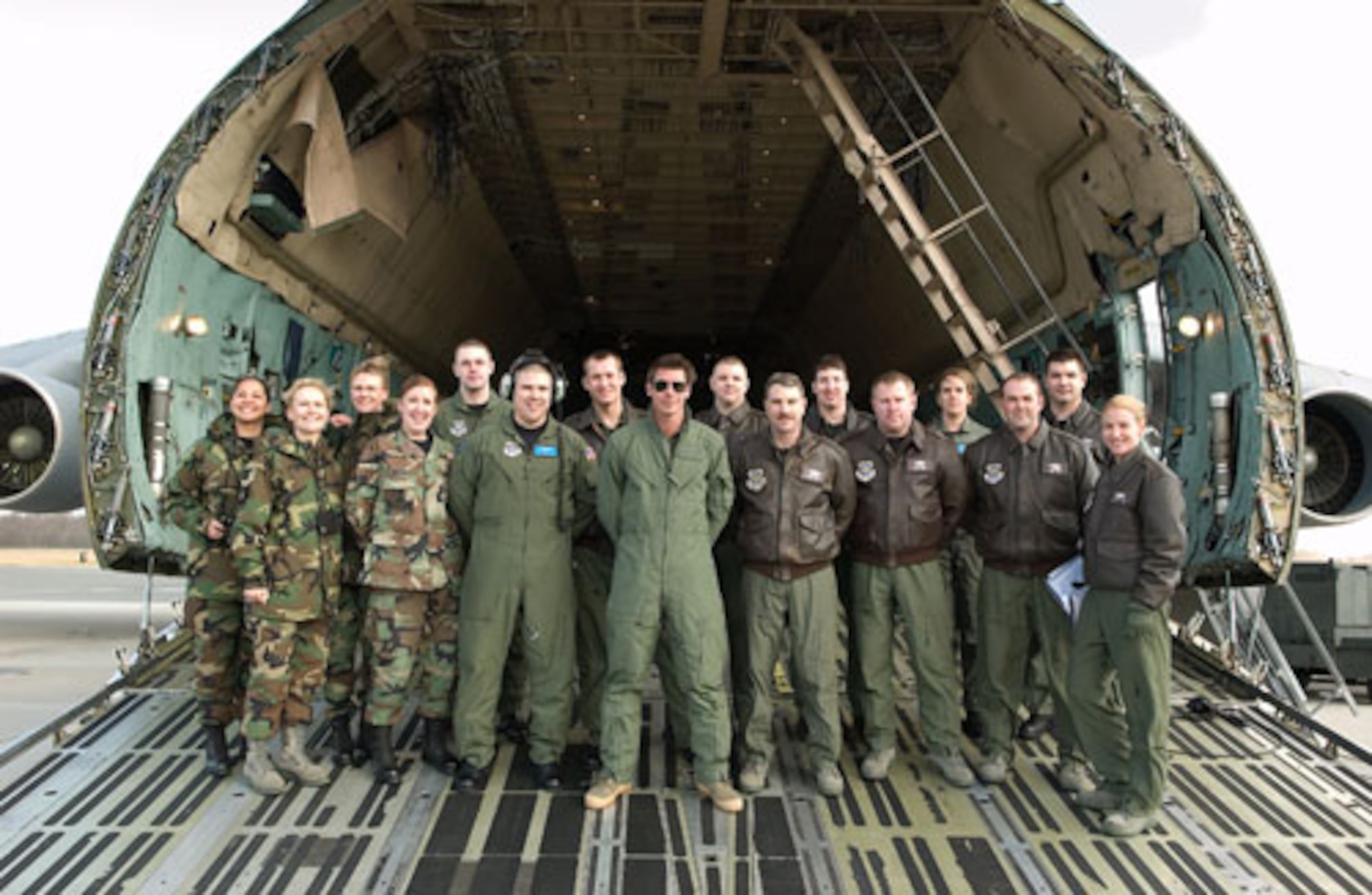 Members of the 436th and 512th Airlift Wings pose with Ty Pennington, the host of ‘Extreme Makeover: Home Edition,’ on a Dover Air Force Base C-5 Galaxy. The teams worked together to film the introduction to an upcoming episode of the show here Feb. 7. (U.S. Air Force photo/Jason Minto)