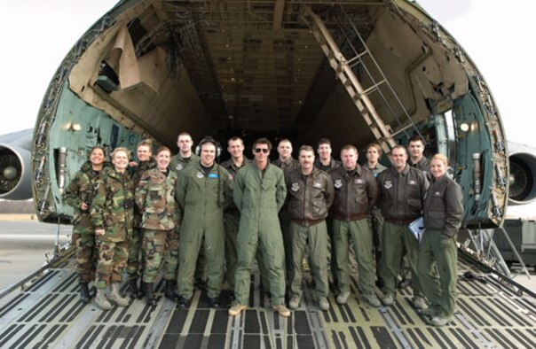 Members of the 436th and 512th Airlift Wings pose with Ty Pennington, the host of ‘Extreme Makeover: Home Edition,’ on a Dover Air Force Base C-5 Galaxy. The teams worked together to film the introduction to an upcoming episode of the show here Feb. 7. (U.S. Air Force photo/Jason Minto)