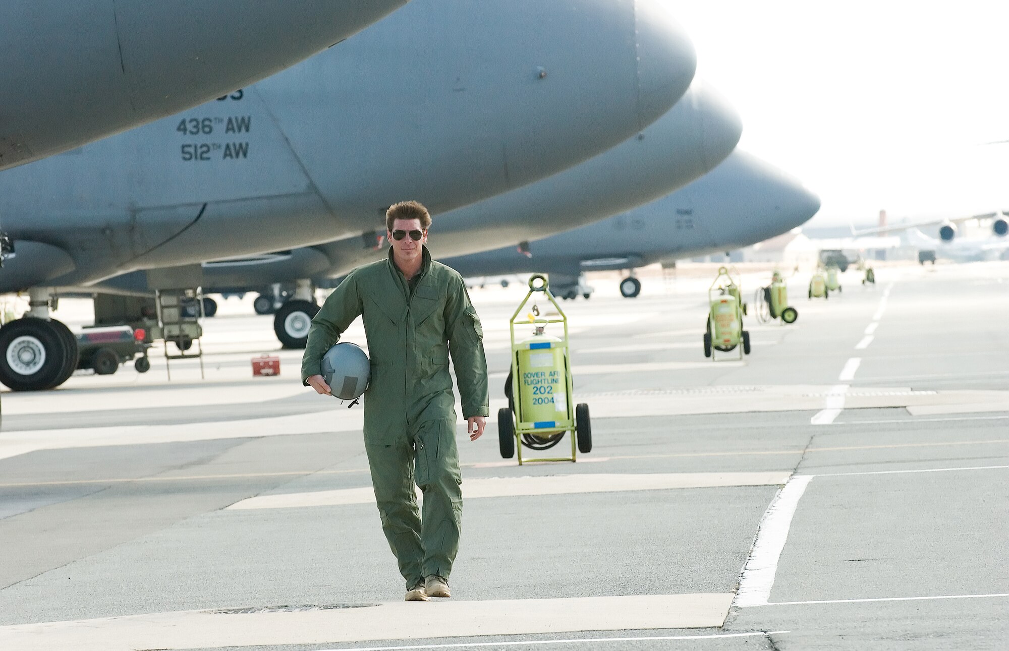 Ty Pennington, host of ‘Extreme Makeover: Home Edition’ walks along a row of C-5 Galaxys on Dover Air Force Base’s flightline Feb. 7. The crew visited Dover AFB Feb. 7 to film the introduction for an upcoming episode of the show, scheduled to air March 30. (U.S. Air Force photo/Jason Minto)