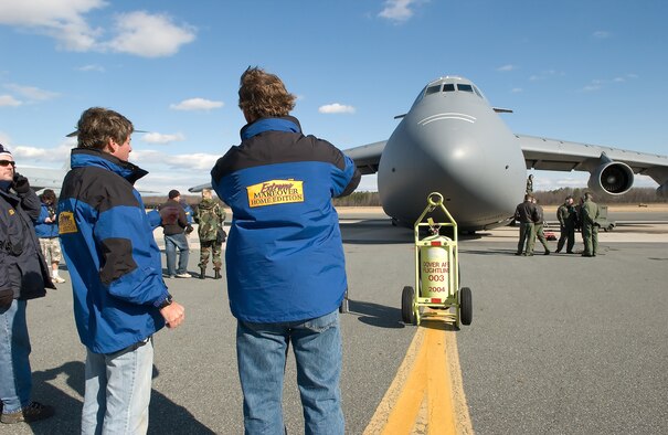 ‘Extreme Makeover: Home Edition’ crew members discuss angles and methods to capture a C-5 Galaxy in the filming of the introduction to an upcoming episode of the show, here Feb. 7. Due to its close proximity to Wilmington, where the crew is remodeling a home, Dover Air Force Base was selected as a location for the show’s introduction. (U.S. Air Force photo/Jason Minto)