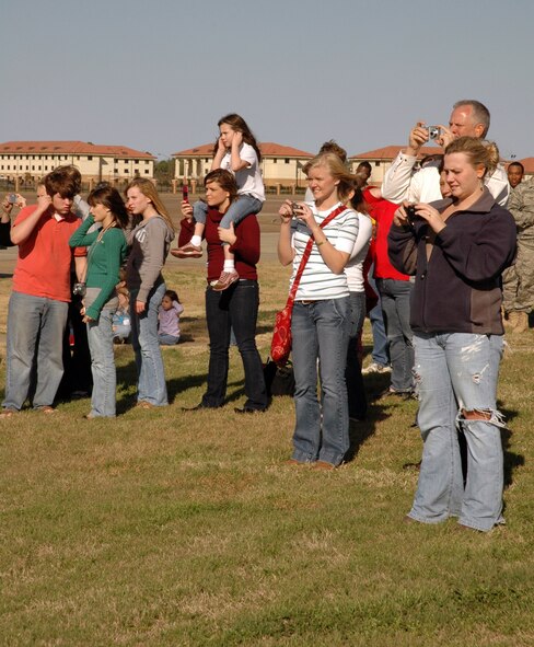 Family members, friends and co-workers mill about near the Maxwell AFB, Ala. flightline Feb. 6, 2008, getting a final glimpse of departing 908th Airlift Wing Air Force Reservists bound for Southwest Asia to provide support for Operation Iraqi Freedom. The Montgomery, Ala.-based wing is the first C-130 unit in Air Force Reserve Command to deploy under a new rotation system filled by volunteers. (U.S. Air Force photo by Mr. Jeff Melvin)