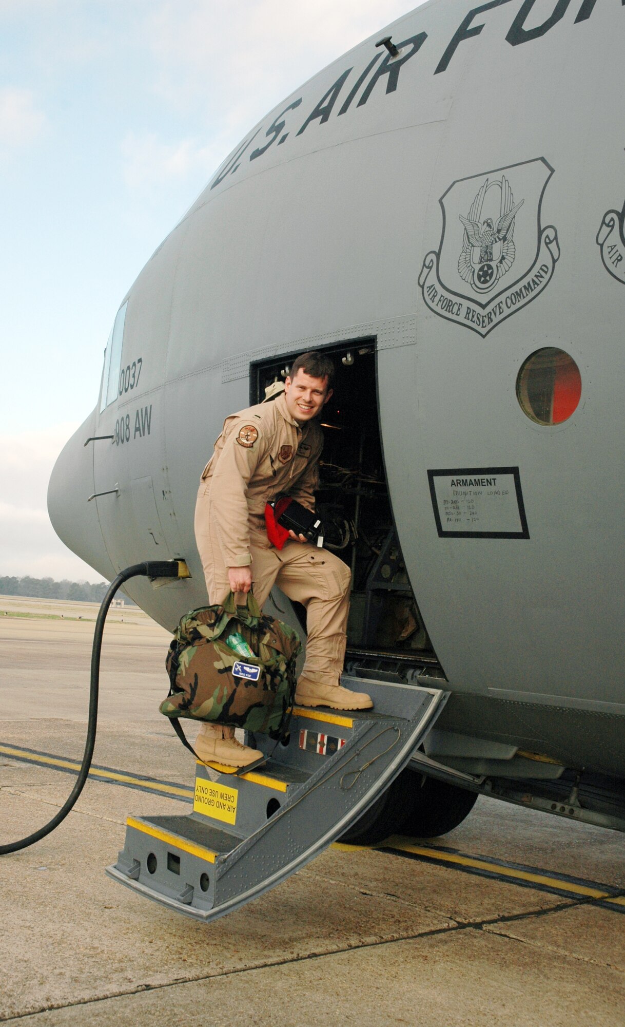 Air Force Reservist 1st Lt. Nick Poe boards an 908th Airlift Wing C-130 bound for Southwest Asia Feb. 5, 2008, to provide support for Operation Iraqi Freedom. The Montgomery, Ala.-based 908th AW the first C-130 unit in Air Force Reserve Command to deploy under a new rotation system filled by volunteers. (U.S. Air Force photo by Mr. Jeff Melvin)