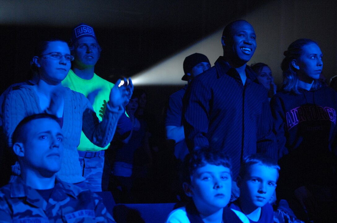 Members of the 28th Bomb Wing gather with their families to watch the Lt. Dan Band perform at the base theater at Ellsworth AFB, S.D. on Feb. 01, 2008.  The private performance for Ellsworth Airmen and their families is the first of the band's stateside United Services Organization tour this year. (U.S. Air Force photo/Airman 1st Class Joshua Seybert)