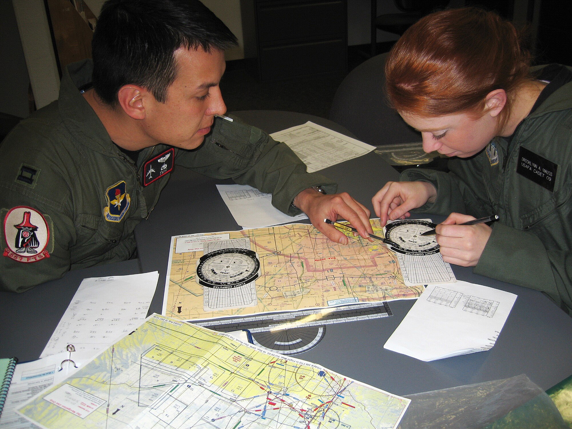 Capt. Steve Priddy and Cadet 2nd Class Brooke Mauss prepare for a flight Feb. 1 at the U.S. Air Force Academy.  Captain Priddy is an instructor pilot with the 557th Flying Training Squadron and Cadet Mauss is a member of Cadet Squadron 5 participating in the "Jump Start" test program.  The test program marks the return to powered flight at the Air Force Academy. (U.S. Air Force photo/Capt. Ginny Walker)