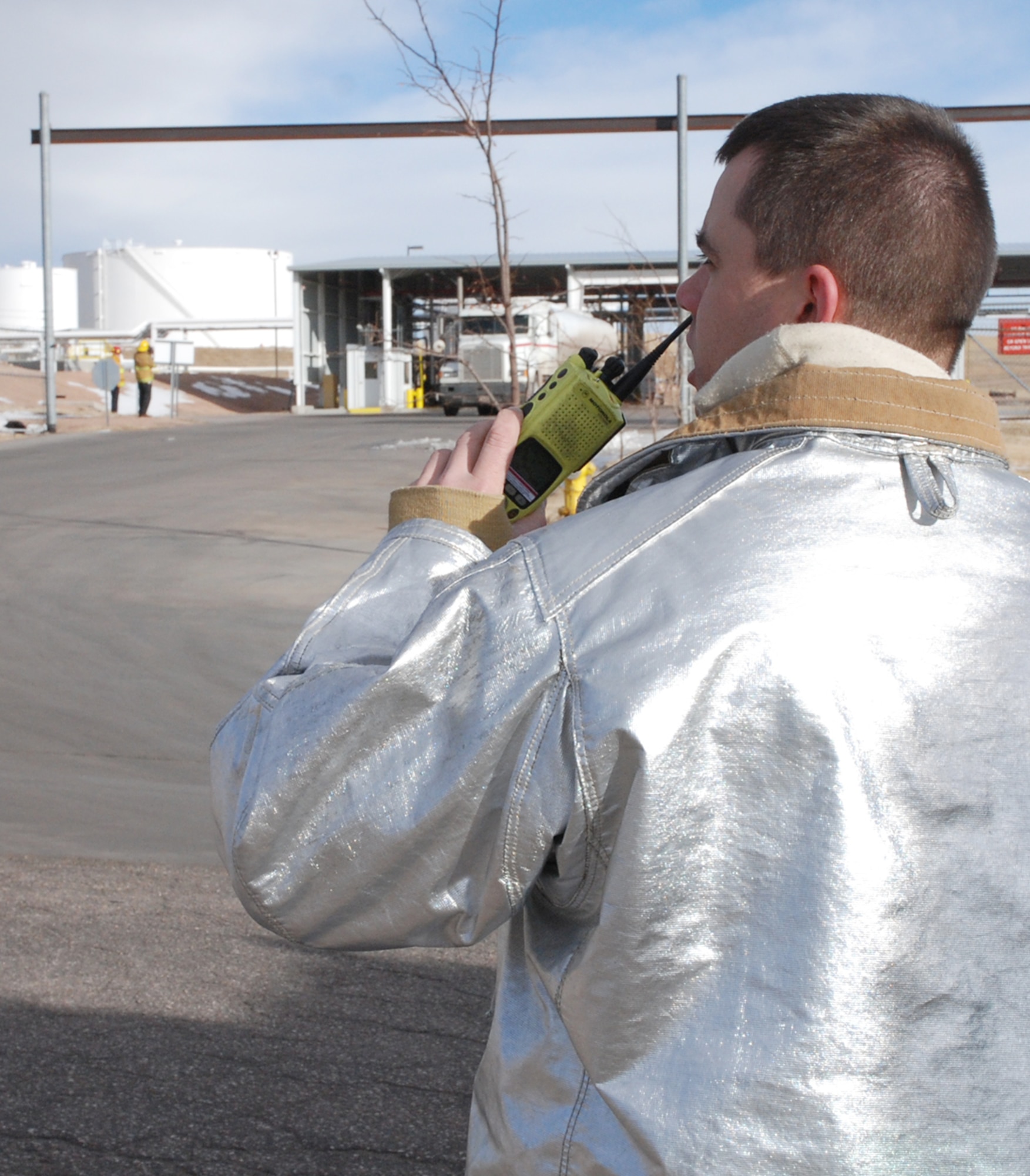 Staff Sgt. Mark Goenen, 21st Civil Engineer Squadron firefighter, coordinates fire response efforts with command and control officials at Peterson Air Force Base, Colo., Feb. 7. Firefighters from Peterson Air Force Base, Colo., and the Colorado Springs Fire Department responded to a fire-related incident at a fueling terminal east of the city. Peterson has several mutual aid agreements with the city of Colorado Springs to support emergency responder situations if asked by local officials. (U.S. Air Force photo/Senior Airman Stephen Collier)
