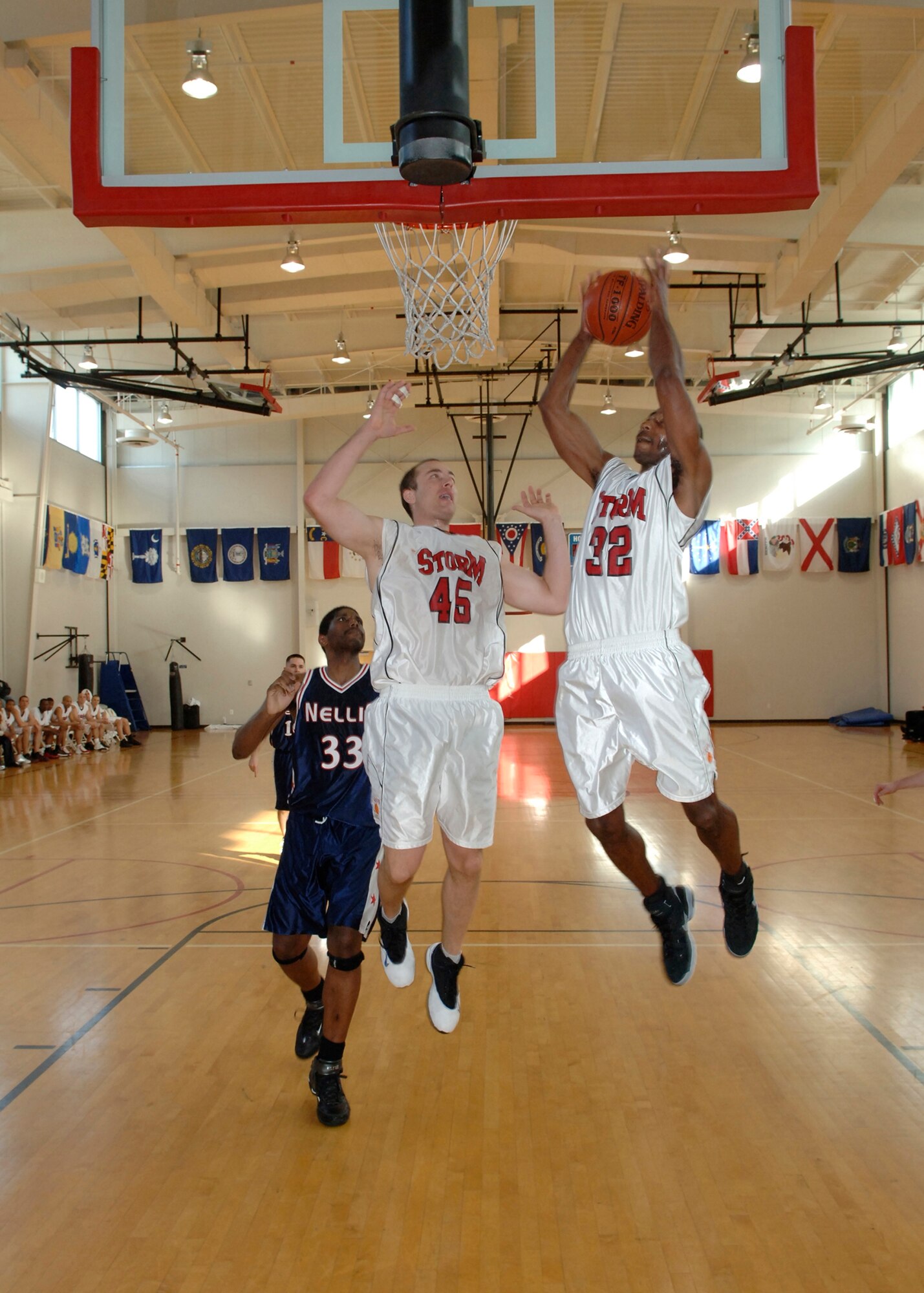 Staff Sgt. Mike Evans scores a basket with an assist from Capt. Tom Bellairs during a game again the visiting Nellis AFB team at the base gym, Jan. 26. The L.A. Storm lost the game 68 to72.  (Photo by Paul Testerman)