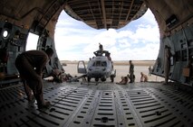 MOODY AIR FORCE BASE, Ga. — Members of Moody’s 723rd Aircraft Maintenance Squadron assist a C-5 Galaxy crew from Dover Air Force Base, Del. with loading an HH-60G Pave Hawk combat search and rescue helicopter here Feb. 6.  The aircraft is one of two being transported from Moody to Balad Air Base, Iraq, in support of Operation Iraqi Freedom. (U.S. Air Force photo by Senior Airman Angelita Lawrence)