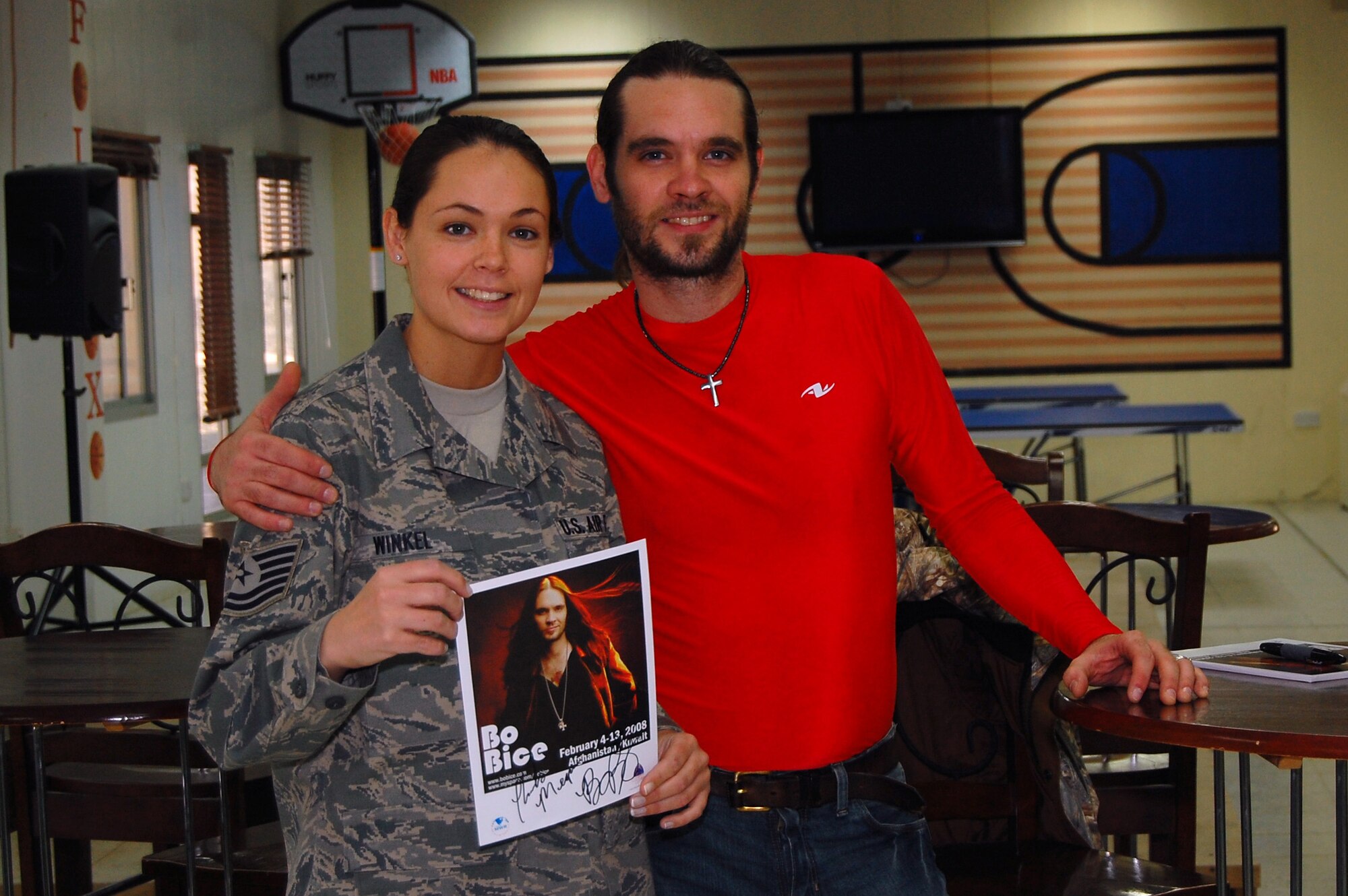 SOUTHWEST ASIA -- Technical Sergeant Megan Winkel, 386th Expeditionary Services Squadron, receives an autograph from American singer and musician Harold Elwin “Bo” Bice Jr. Feb. 7, 2008, at an air base in the Persian Gulf Region. Bo Bice is visiting servicemembers deployed to Southwest Asia in support of Operations Enduring and Iraqi Freedom during his Stars for Stripes tour. Sergeant Winkel is deployed from the 152nd Airlift Wing in Reno, Nev. (U.S. Air Force photo/ Staff Sergeant Patrick Dixon)