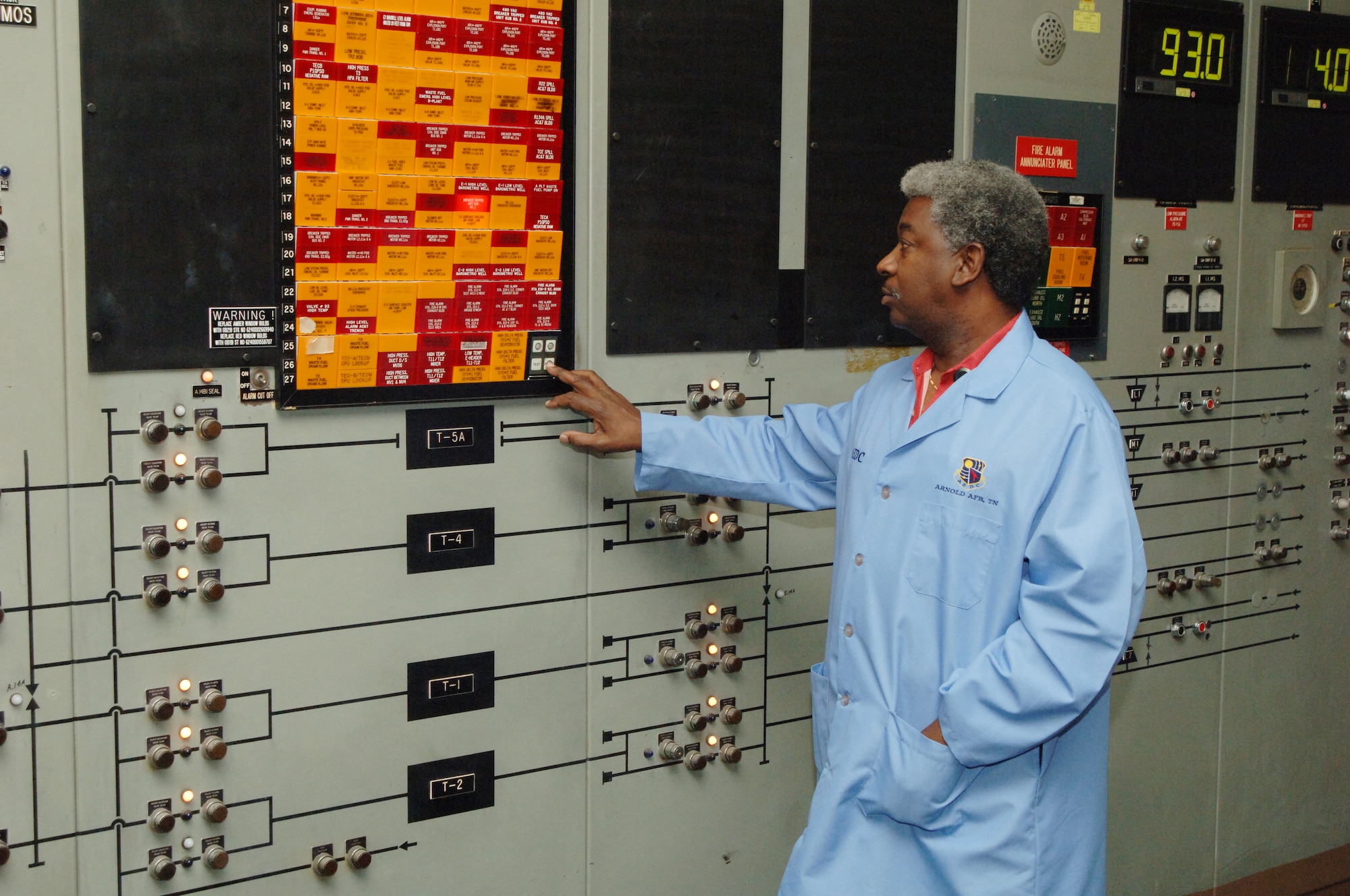 Waymond “Buck” Buchanan, Aerospace Testing Alliance electrician technician lead at Arnold Engineering Development Center's B-Plant, resets an alarm on the plant’s alarm panel. The alarms are color-coded red or yellow to indicate the urgency of a potential problem with the flow of water, aviation fuel or air. The panel also includes fire alarm indicators for the plant. (Photo by David Housch)