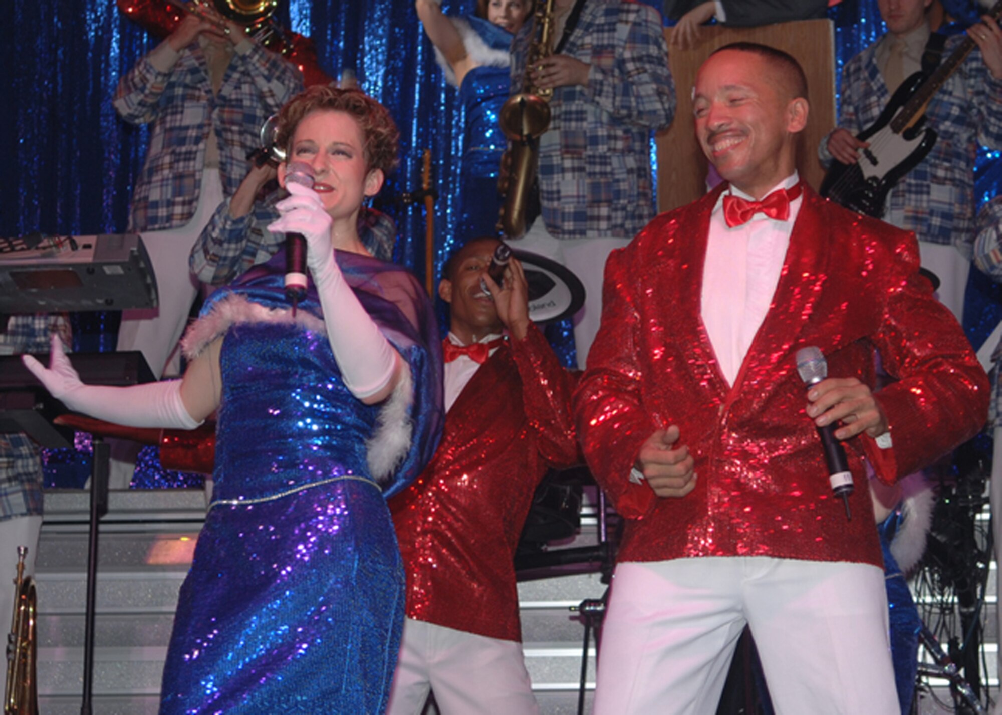 Senior Airman April Vollm and Tech. Sgt. Keith Martin, 43rd Flying Training Squadron, sing a duet during the Tops in Blue performance Monday. (U.S. Air Force photo by Elizabeth Owens)