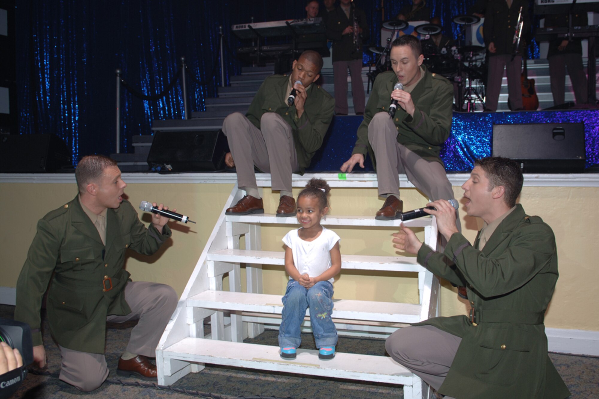 The expeditionary entertainers known as the Tops in Blue sing to Daijah Kelley, daughter of Tech. Sgts. David and Jennifer Kelley, during their performance Monday night. (U.S. Air Force photo by Elizabeth Owens)