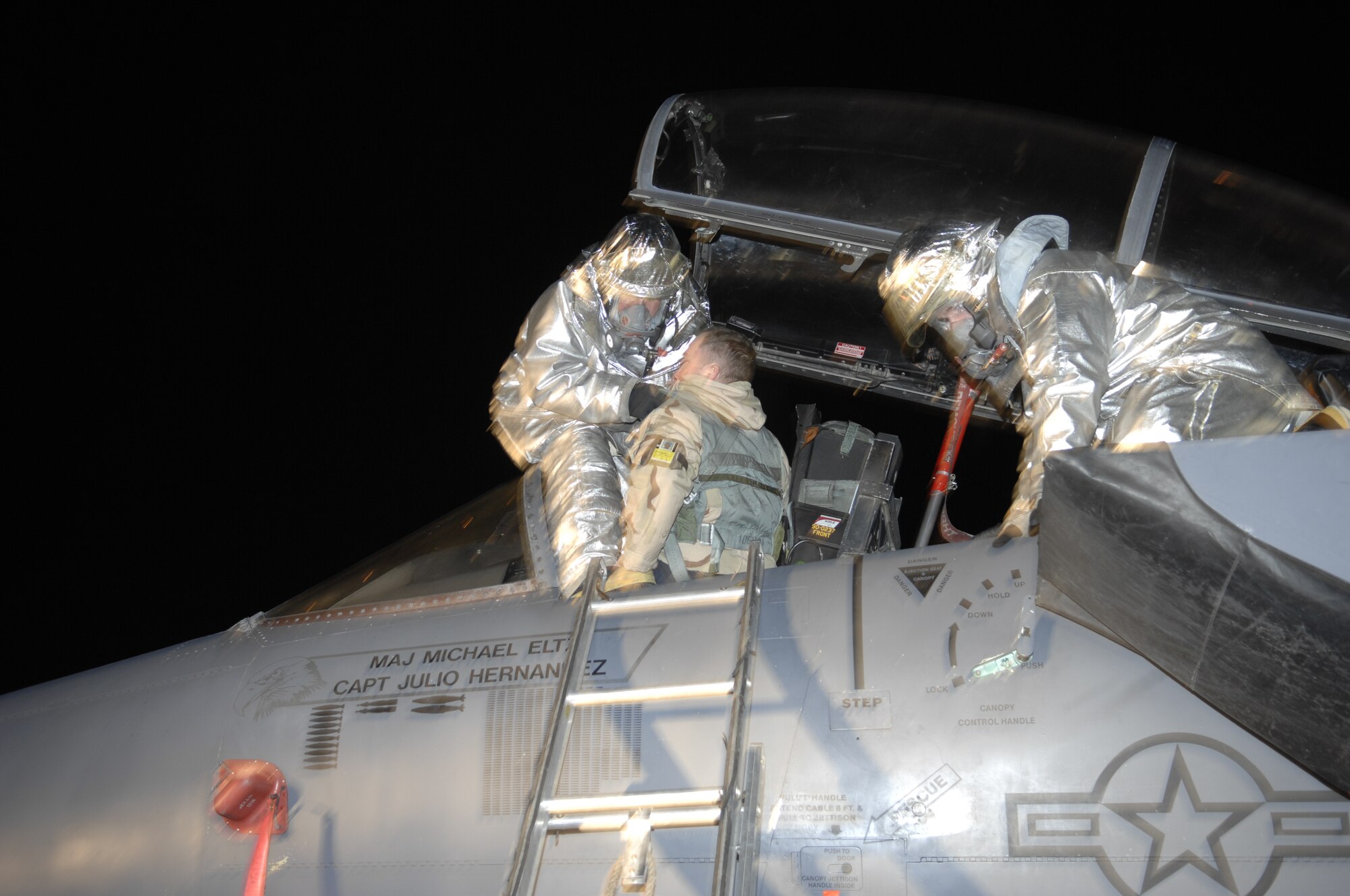 MOUNTAIN HOME AIR FORCE BASE, Idaho - Members of the 366th Civil Engineer Squadron fire and emergency services flight, participate in an aircrew extraction during Exercise Sharpshooter 08-03 here, Feb. 6. The firefighters remove a wounded pilot from the cockpit of an F-15E. The 366th Fighter Wing conducts exercises to prepare personnel and equipment for the upcoming March 2008 Operational Readiness Inspection. (U.S. Air Force photo by Senior Airman Dana D. Hill)