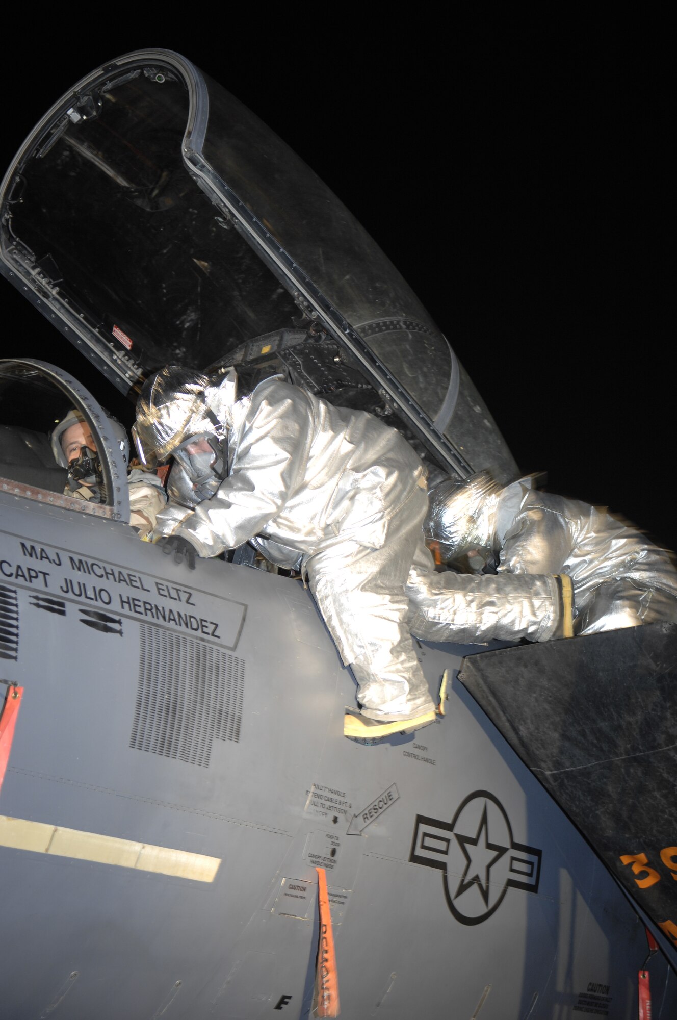 MOUNTAIN HOME AIR FORCE BASE, Idaho - Members of the 366th Civil Engineer Squadron fire and emergency services flight, participate in an aircrew extraction during Exercise Sharpshooter 08-03 here, Feb. 6. The firefighters remove a wounded pilot from the cockpit of an F-15E. The 366th Fighter Wing conducts exercises to prepare personnel and equipment for the upcoming March 2008 Operational Readiness Inspection. (U.S. Air Force photo by Senior Airman Dana D. Hill)