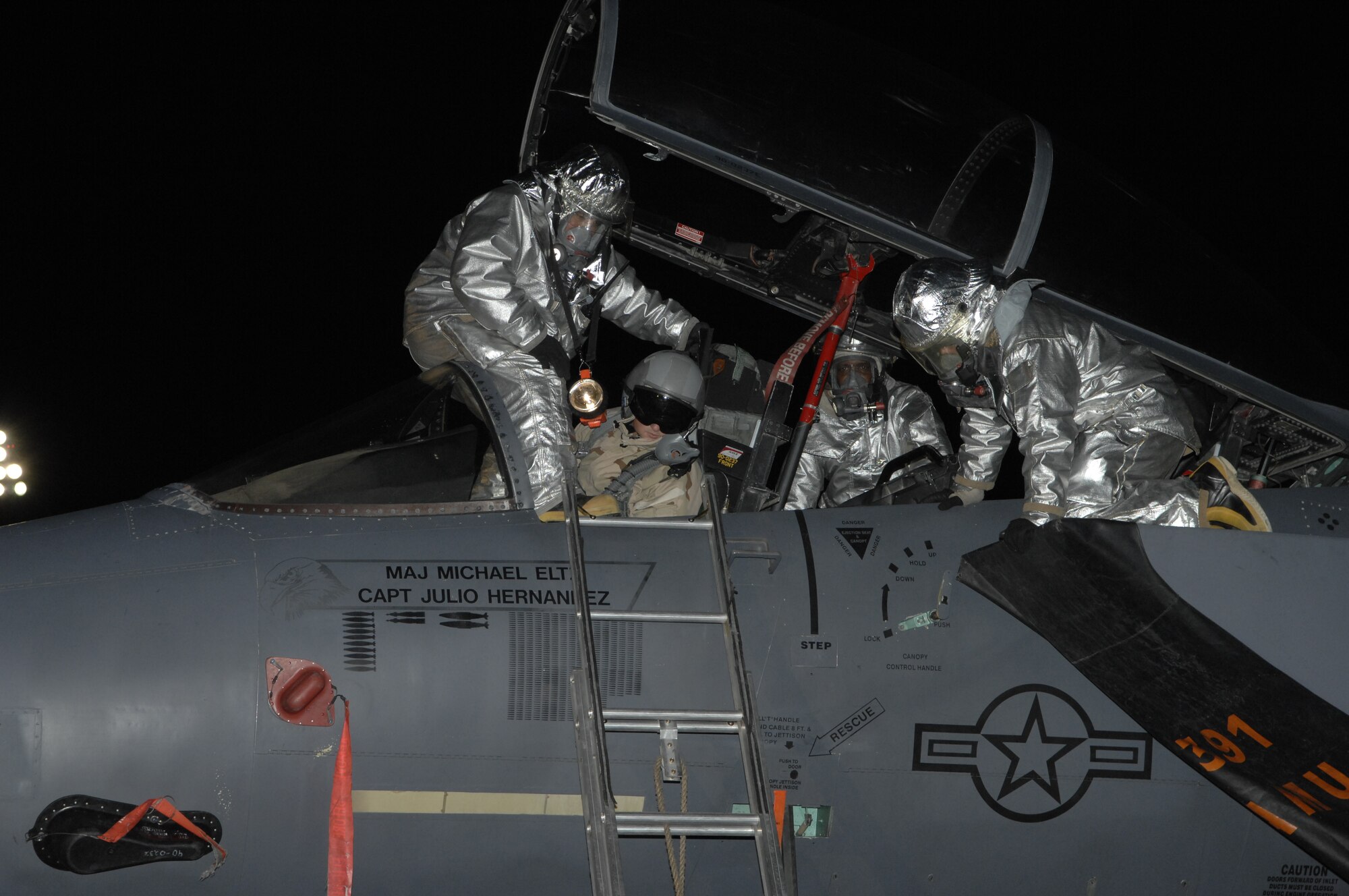 MOUNTAIN HOME AIR FORCE BASE, Idaho - Members of the 366th Civil Engineer Squadron fire and emergency services flight, participate in an aircrew extraction during Exercise Sharpshooter 08-03 here, Feb. 6. The firefighters remove a wounded pilot from the cockpit of an F-15E. The 366th Fighter Wing conducts exercises to prepare personnel and equipment for the upcoming March 2008 Operational Readiness Inspection. (U.S. Air Force photo by Senior Airman Dana D. Hill)