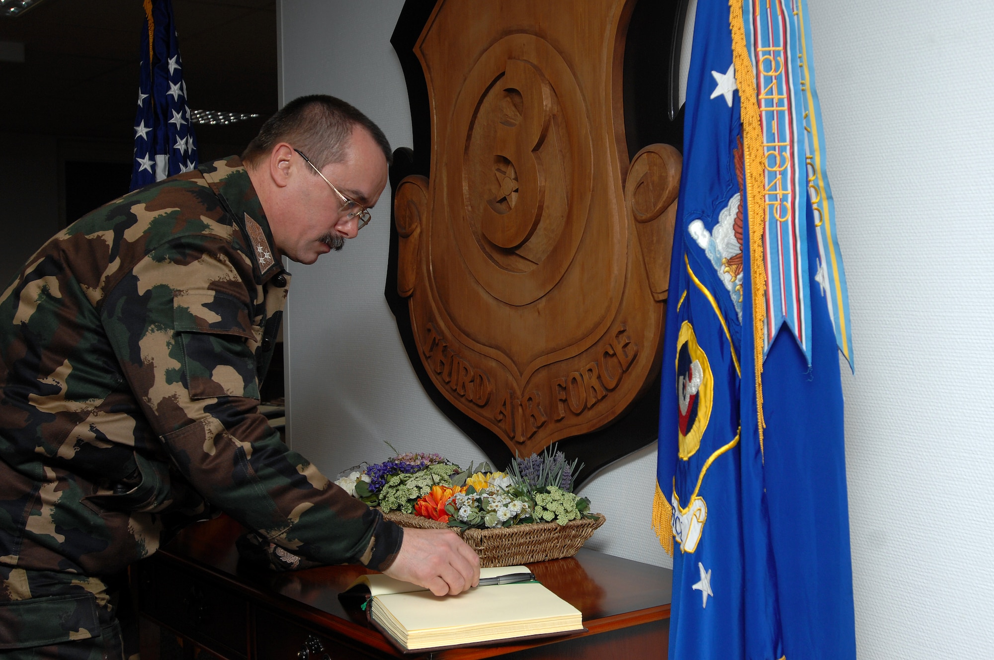 Lieutenant Gen. Laszlo Tombol, Commander Hungarian Joint Forces Command, signs the 3rd Air Force guest book in Lt Gen. Rod Bishop's office Feb, 6 on Ramstein. General Bishop and the 3rd Air Force played host to the Hungarian general and discussed important topics helping both countries make head way on the war on terror. (U.S. Air Force Photo/Airman 1st Class Kenny Holston) 