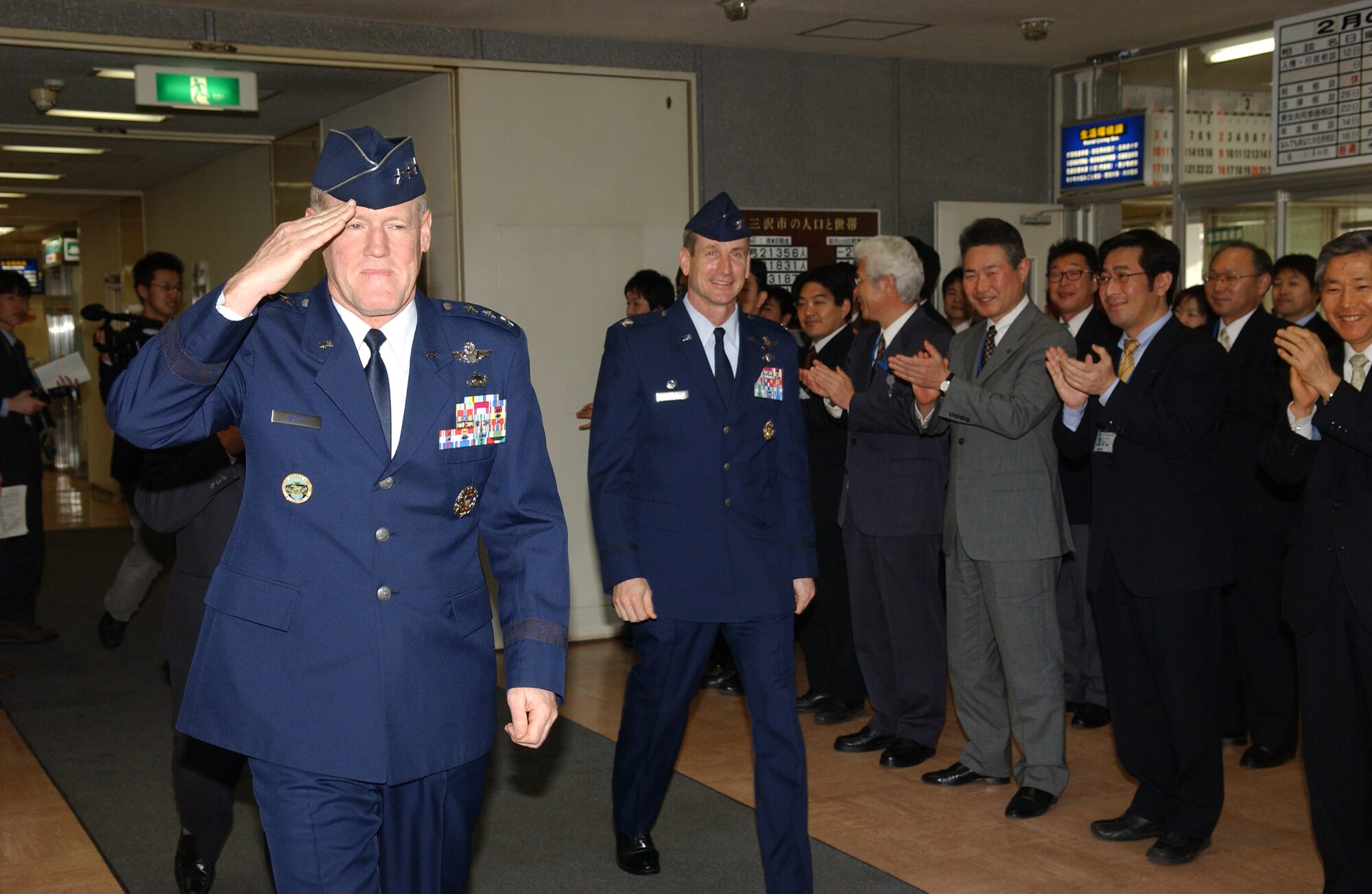 MISAWA AIR BASE, Japan -- Lt. Gen. Bruce Wright (left), 5th Air Force commander, salutes Misawa City Hall staff after a visit with Misawa City mayor Kazumasa Taneichi at Misawa City Hall on Feb. 5, 2008. General Wright visited Misawa for his final flight on Feb. 6, 2008.  (U.S. Air Force photo by Senior Airman Robert Barnett)