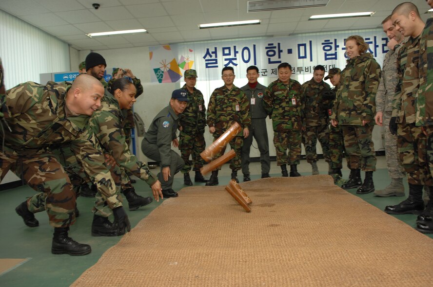 KUNSAN AIR BASE, South Korea --  Members of the ROKAF 38th Fighter Group and the 8th Fighter Wing participate in traditional Korean games in celebration of the Korean Lunar New Year here Feb. 7. The Lunar New Year event is one of many events hosted by ROKAF members in order to strengthen ties and gain cultural awareness with U.S. military members.  (ROKAF photo/Master Sgt. Choi Yong Sik) 