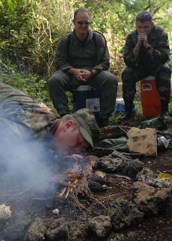 Andersen AFB, Guam -- U.S.Air Force Major Kevin Templin and 1Lt. Shane Erickson listen as Staff Sergeant Brooks Steinbacher, Survival Evasion Resistance and Escape Specialist from the 509th Operational Support Squadron, instructs a group of B-2 Spirit pilots from the 393rd Expeditionary Bomb Squadron about building a fire in adverse tropical conditions.  The 393 EBS pilots learned basic combat survival tactics during a two day SERE refresher course. The B-2 Spirit bomber pilots are deployed from Whiteman AFB, MO.
(U.S. Air Force Photo By Staff Sgt. Vanessa Valentine) 