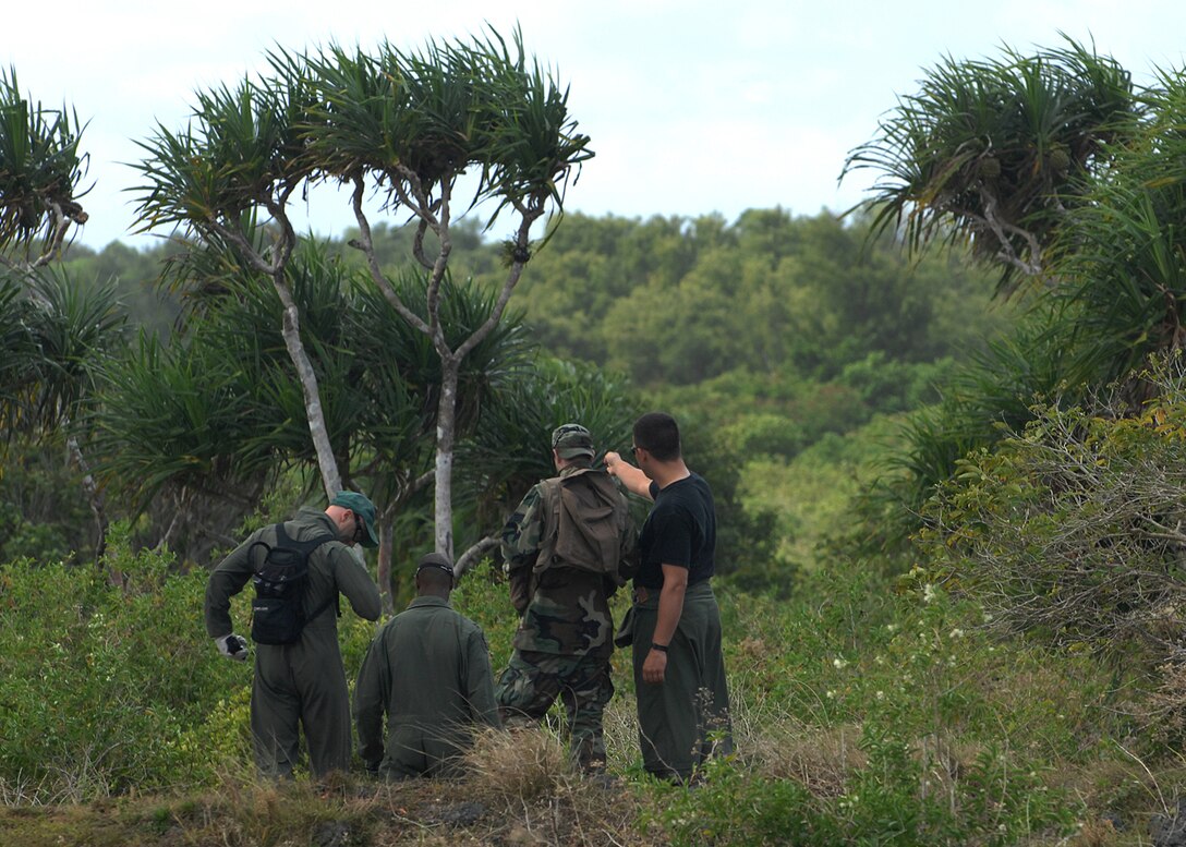 Andersen AFB, Guam -- A team of B-2 Spirit pilots from the 393rd Expeditionary Bomb Squadron begin their expedition through the jungle. They are being led by the global positioning device to a set of predesignated coordinates where they will later be picked up by helicopter. The pilots underwent a two day refresher course on survival evasion resistance and escape techniques specific to the tropical climate. The B-2 Spirit bomber pilots are deployed from Whitman AFB, MO.
(U.S. Air Force Photo By Staff Sgt. Vanessa Valentine) 