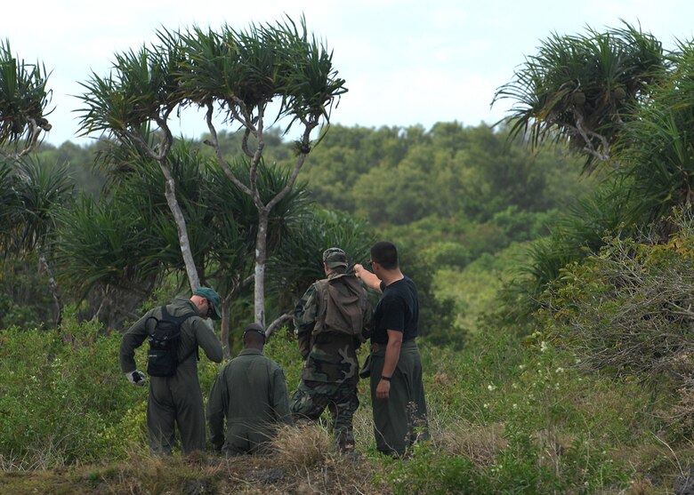 Andersen AFB, Guam -- A team of B-2 Spirit pilots from the 393rd Expeditionary Bomb Squadron begin their expedition through the jungle. They are being led by the global positioning device to a set of predesignated coordinates where they will later be picked up by helicopter. The pilots underwent a two day refresher course on survival evasion resistance and escape techniques specific to the tropical climate. The B-2 Spirit bomber pilots are deployed from Whitman AFB, MO.
(U.S. Air Force Photo By Staff Sgt. Vanessa Valentine) 