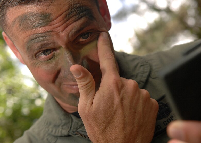 Andersen AFB, Guam -- U.S.Air Force Lt. Col. Todd Copeland conceals his face for the evasion portion of training. A group of B-2 Spirit pilots from the 393rd Expeditionary Bomb Squadron.The 393 EBS pilots learned basic combat survival tactics during a two day SERE refresher course. The B-2 Spirit bomber pilots are deployed from Whitman AFB, MO.
(U.S. Air Force Photo By Staff Sgt. Vanessa Valentine) 