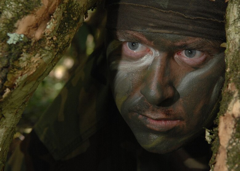 Andersen AFB, Guam -- U.S.Air Force Staff Sergeant Brooks Steinbacher, Survival Evasion Resistance and Escape Specialist from the 509th Operational Support Squadron, demonstrates  tropical environment evasion and concealment techniques to a group of B-2 Spirit pilots from the 393rd Expeditionary Bomb Squadron.The 393 EBS pilots learned basic combat survival tactics during a two day SERE refresher course. The B-2 Spirit bomber pilots are deployed from Whitman AFB, MO.
(U.S. Air Force Photo By Staff Sgt. Vanessa Valentine) 