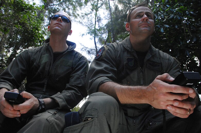 Andersen AFB, Guam -- U.S.Air Force Lt. Col. Tod Copeland and Captian Geoff Romanowicz program coordinates into their global positioning system. B-2 Spirit pilots from the 393rd Expeditionary Bomb Squadron used the GPS system to find their way though the thick jungle where they would later be picked up by helicopter during a two day refresher course on survival evasion resistance and escape techniques specific to the tropical climate. The B-2 Spirit bomber pilots are deployed from Whiteman AFB, MO.
(U.S. Air Force Photo By Staff Sgt. Vanessa Valentine) 
