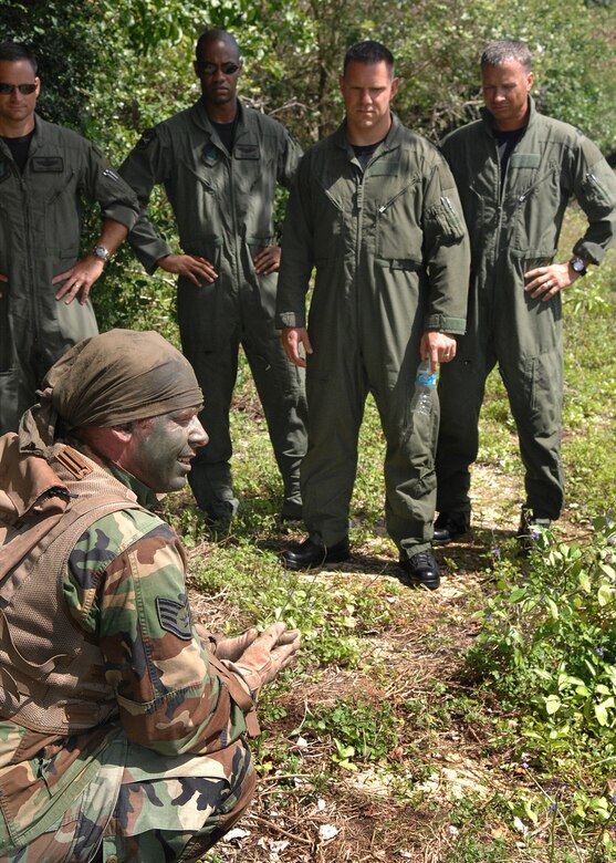 Andersen AFB, Guam -- U.S.Air Force Staff Sergeant Brooks Steinbacher, Survival Evasion Resistance and Escape Specialist from the 509th Operational Support Squadron, instructs a group of B-2 Spirit pilots from the 393rd Expeditionary Bomb Squadron evasion and concealment techniques in a tropical environment.  The 393 EBS pilots learned basic combat survival tactics during a two day SERE refresher course. The B-2 Spirit bomber pilots are deployed from Whitman AFB, MO.
(U.S. Air Force Photo By Staff Sgt. Vanessa Valentine) 
