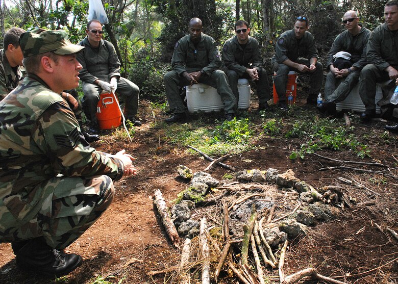 Andersen AFB, Guam -- U.S.Air Force Staff Sergeant Brooks Steinbacher, Survival Evasion Resistance and Escape Specialist from the 509th Operational Support Squadron, instructs a group of B-2 Spirit pilots from the 393rd Expeditionary Bomb Squadron about building a fire in adverse tropical conditions.  The 393 EBS pilots learned basic combat survival tactics during a two day SERE refresher course. The B-2 Spirit bomber pilots are deployed from Whiteman AFB, MO.
(U.S. Air Force Photo By Staff Sgt. Vanessa Valentine) 