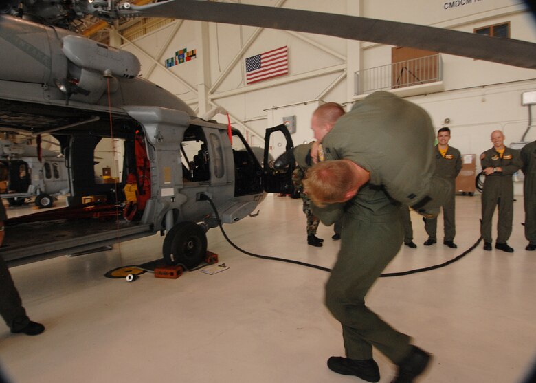 Andersen AFB, Guam -- U.S.Air Force Captain John Blase, 393rd Expeditionary Bomb Squadron,  is carried to a Navy MH-60S helicopter. 393 EBS pilots learned about helicopter medical evacuation procedures during a two day refresher course on survival evasion resistance and escape techniques specific to the tropical climate. The B-2 Spirit bomber pilots are deployed from Whiteman AFB, MO.
(U.S. Air Force Photo By Staff Sgt. Vanessa Valentine) 