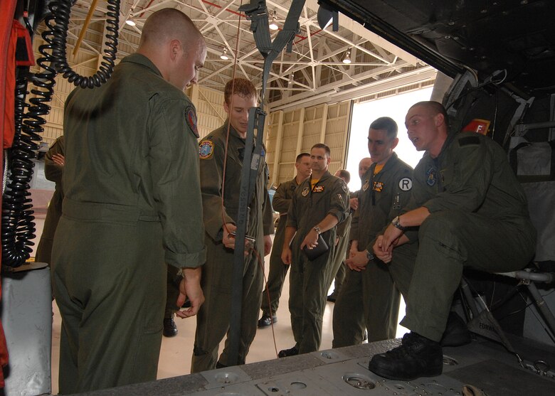 Andersen AFB, Guam -- U.S. Navy Aviation System Operator Second Class Dave Bernhardt and Aviation System Operator Third Class Jeremy Gardner explains the medical evacuation procedures on a MH-60S helicopter to a group of B-2 Spirit pilots from the 393rd Expeditionary Bomb Squadron. The pilots underwent a two day refresher course on survival evasion resistance and escape tactics specific to the tropical climate. The 393 EBS B-2 Spirit pilots are deployed from Whiteman AFB, MO.
(U.S. Air Force Photo By Staff Sgt. Vanessa Valentine) 