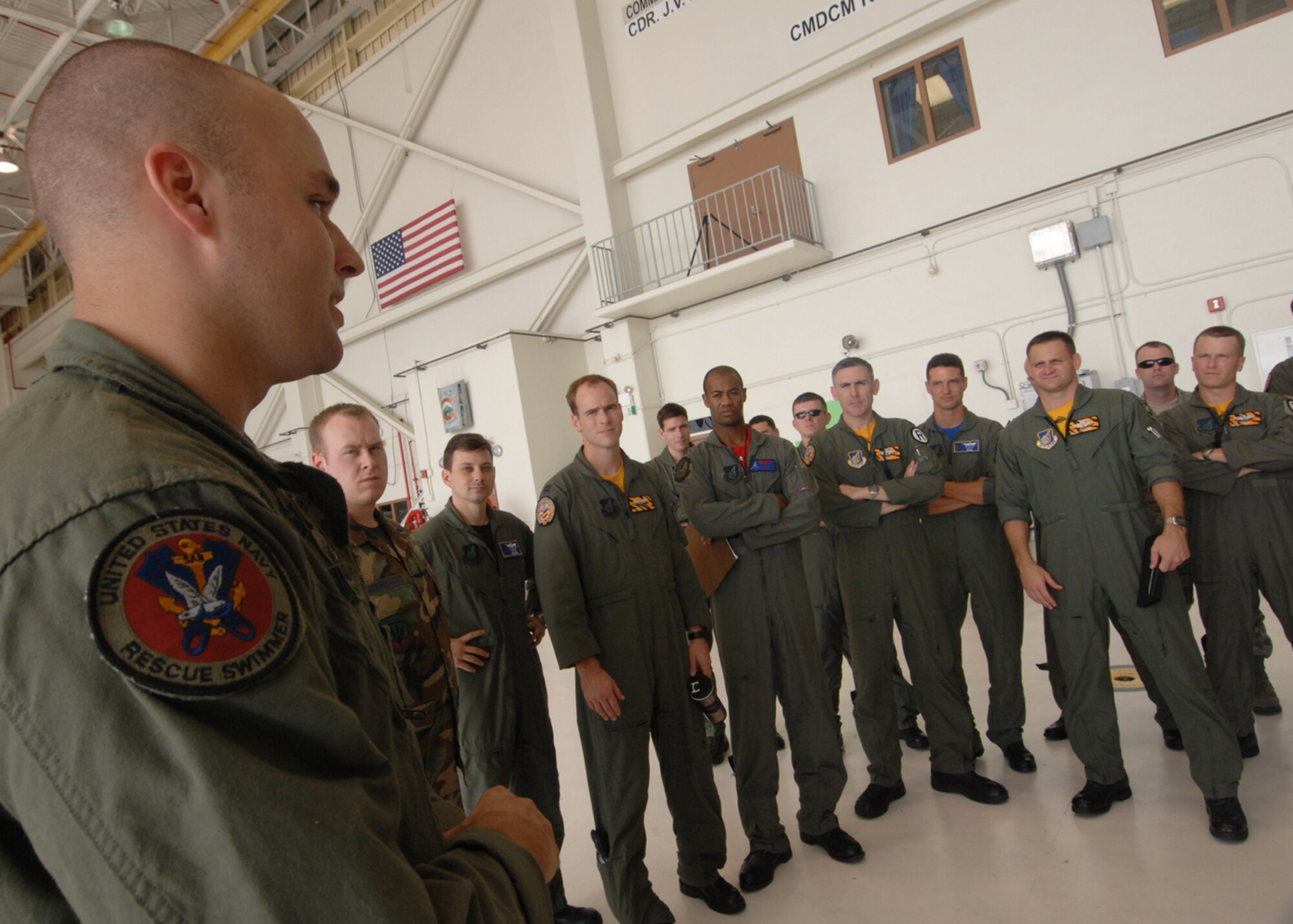 Andersen AFB, Guam -- U.S. Navy Aviation System Operator Second Class Dave Bernhardt explains the medical evacuation procedures on a MH-60S helicopter to a group of B-2 Spirit pilots from the 393rd Expeditionary Bomb Squadron. The pilots underwent a two day refresher course on survival evasion resistance and escape tactics specific to the tropical climate. The 393 EBS B-2 Spirit pilots are deployed from Whiteman AFB, MO.
(U.S. Air Force Photo By Staff Sgt. Vanessa Valentine) 