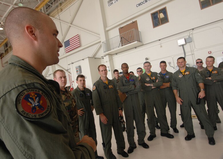 Andersen AFB, Guam -- U.S. Navy Aviation System Operator Second Class Dave Bernhardt explains the medical evacuation procedures on a MH-60S helicopter to a group of B-2 Spirit pilots from the 393rd Expeditionary Bomb Squadron. The pilots underwent a two day refresher course on survival evasion resistance and escape tactics specific to the tropical climate. The 393 EBS B-2 Spirit pilots are deployed from Whiteman AFB, MO.
(U.S. Air Force Photo By Staff Sgt. Vanessa Valentine) 
