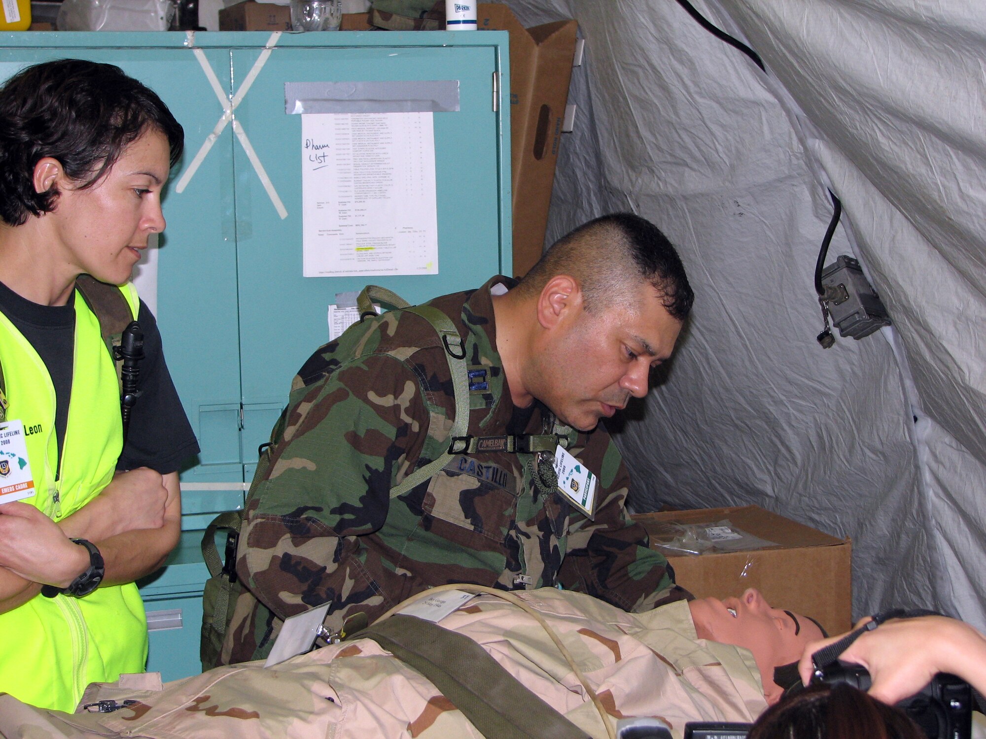 Chaplain (Capt.) Paul Castillo, a protestant chaplain assigned to the 36th Wing, Andersen Air Force Base, Guam, consoles a simulated patient while receiving injects from Tech. Sgt. Belen DeLeon, an U.S. Air Force School of Aerospace Medicine instructor from Brooks City-Base, Texas, during a mass casualty exercise Feb. 4.  Chaplain Castillo deployed to the Kona (Hawaii) International Airport from Andersen with the 36th Contingency Response Group to participate in exercise Pacific Lifeline. (U.S. Air Force photo by Senior Master Sgt. Charles Ramey)