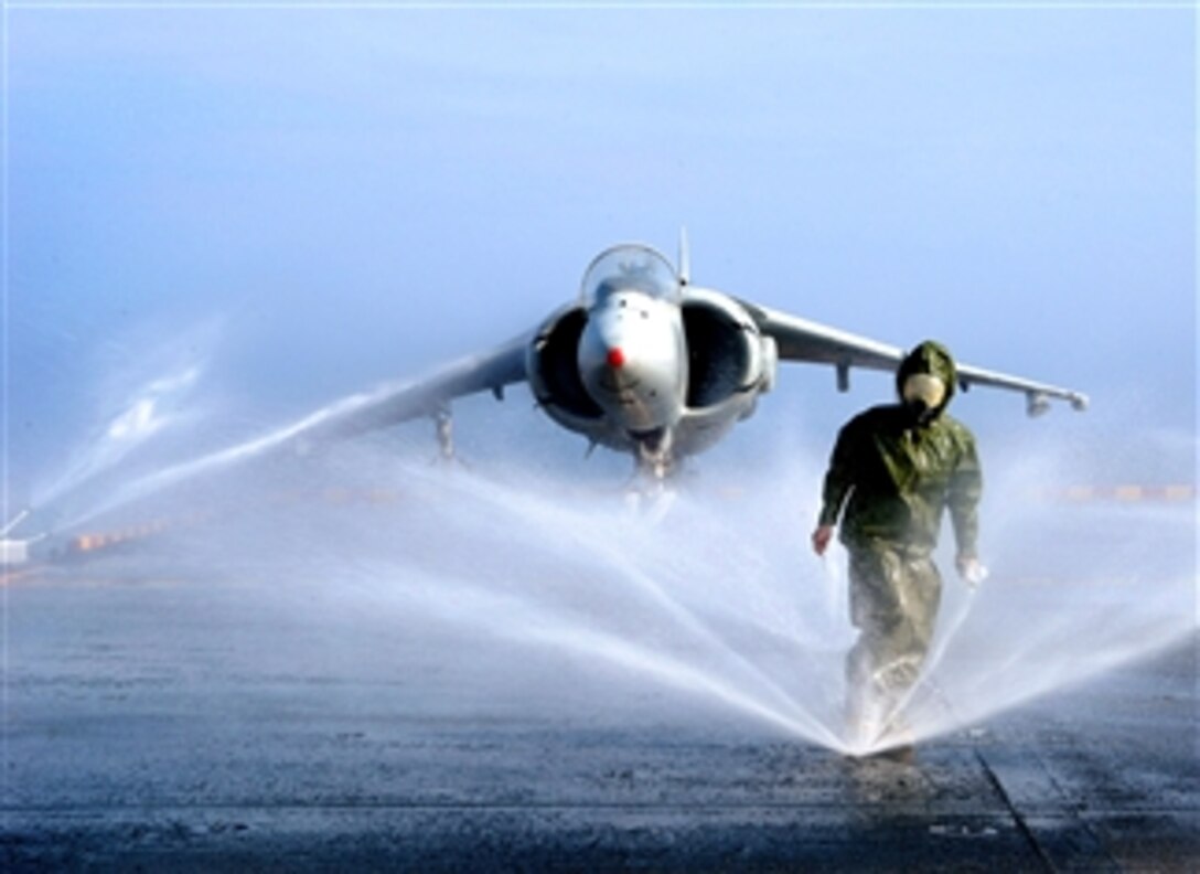 U.S. Navy Petty Officer Felicia Garcia checks sprinklers for blockage on the wash down system of the USS Iwo Jima, Feb. 5, 2008. 